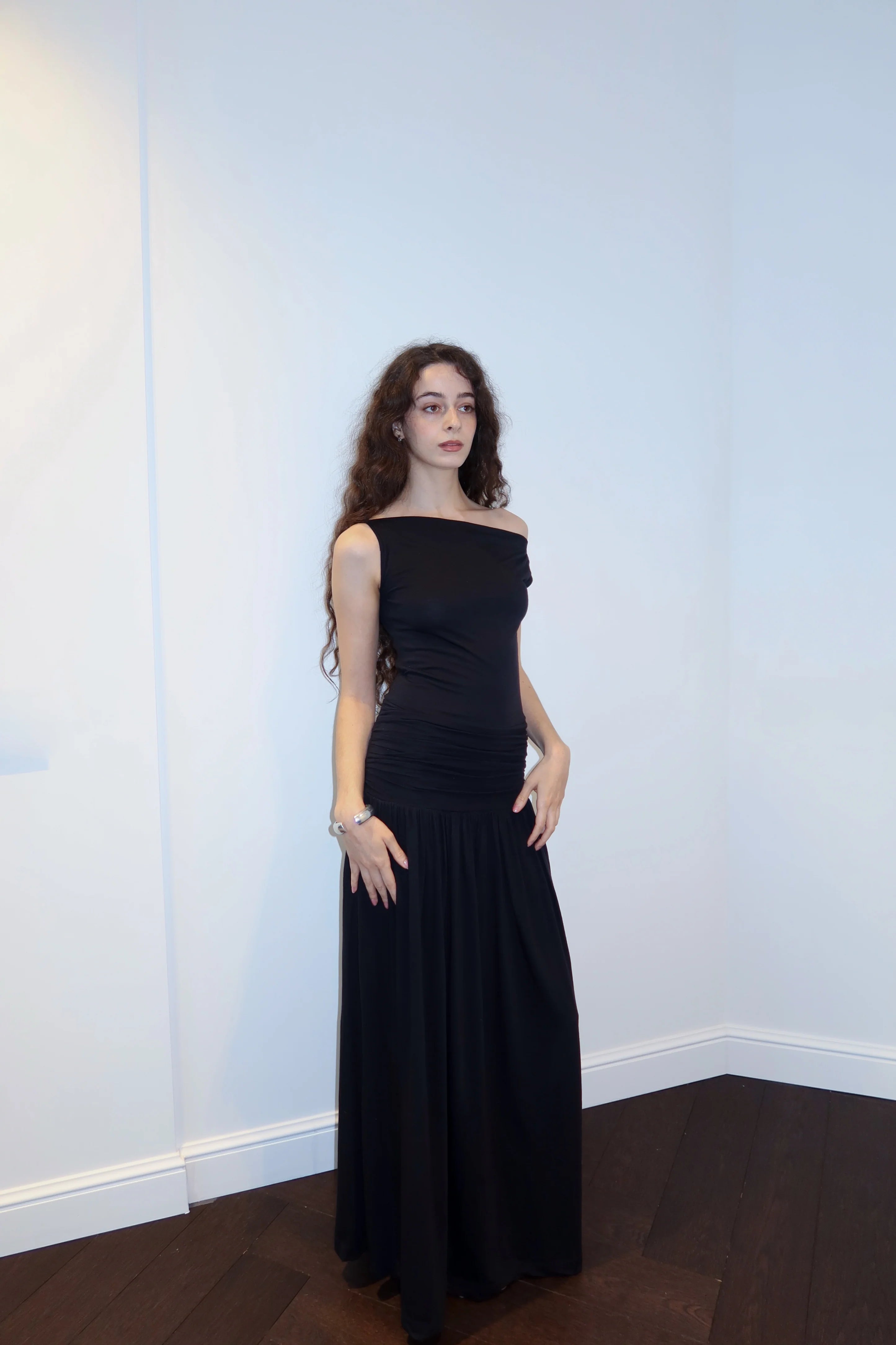 A model wearing the phase silk jersey dress in a white background. 100% made from deadstock.