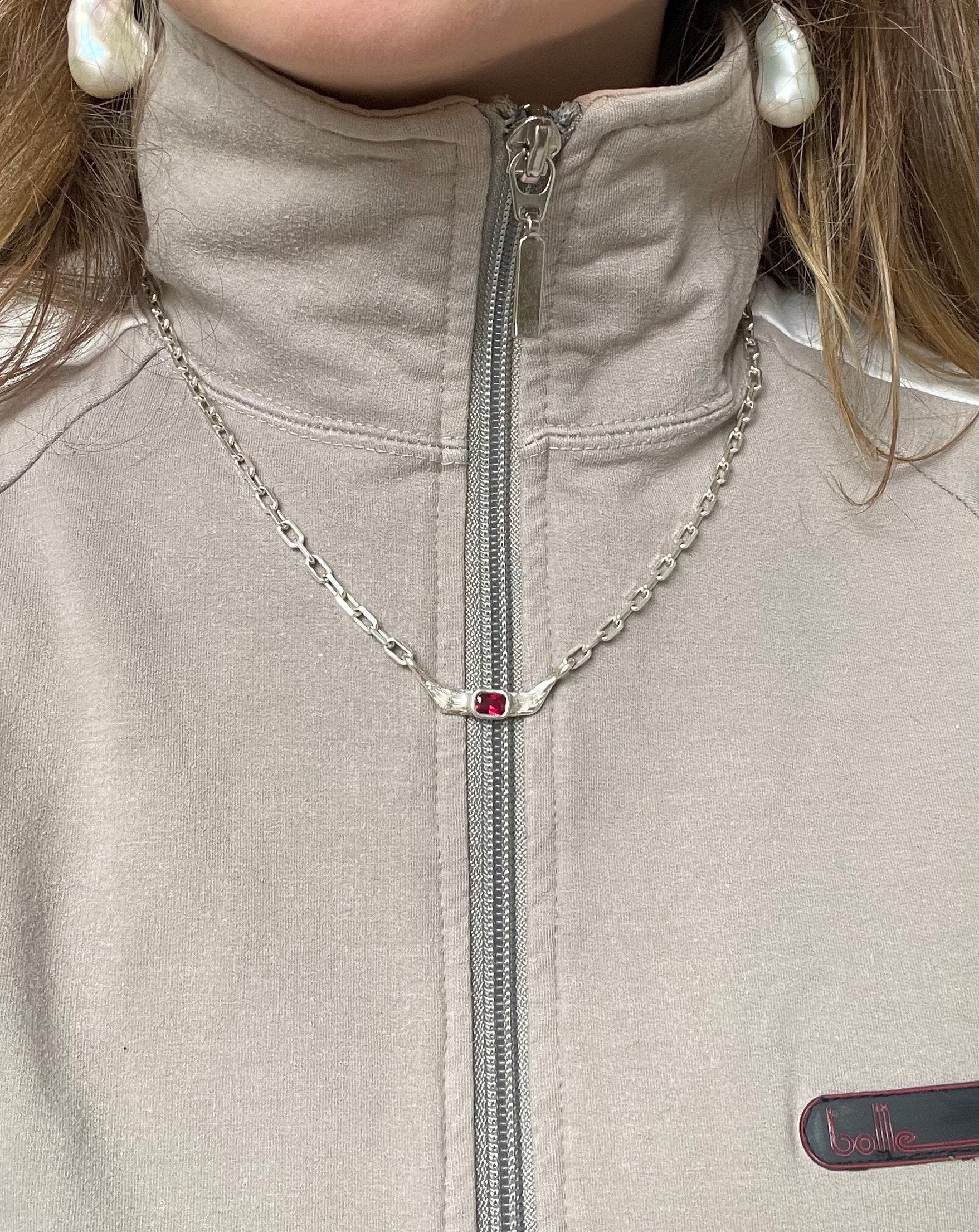 A model wearing the pixie necklace. Made from 100% recycled metals and lab created gemstones.