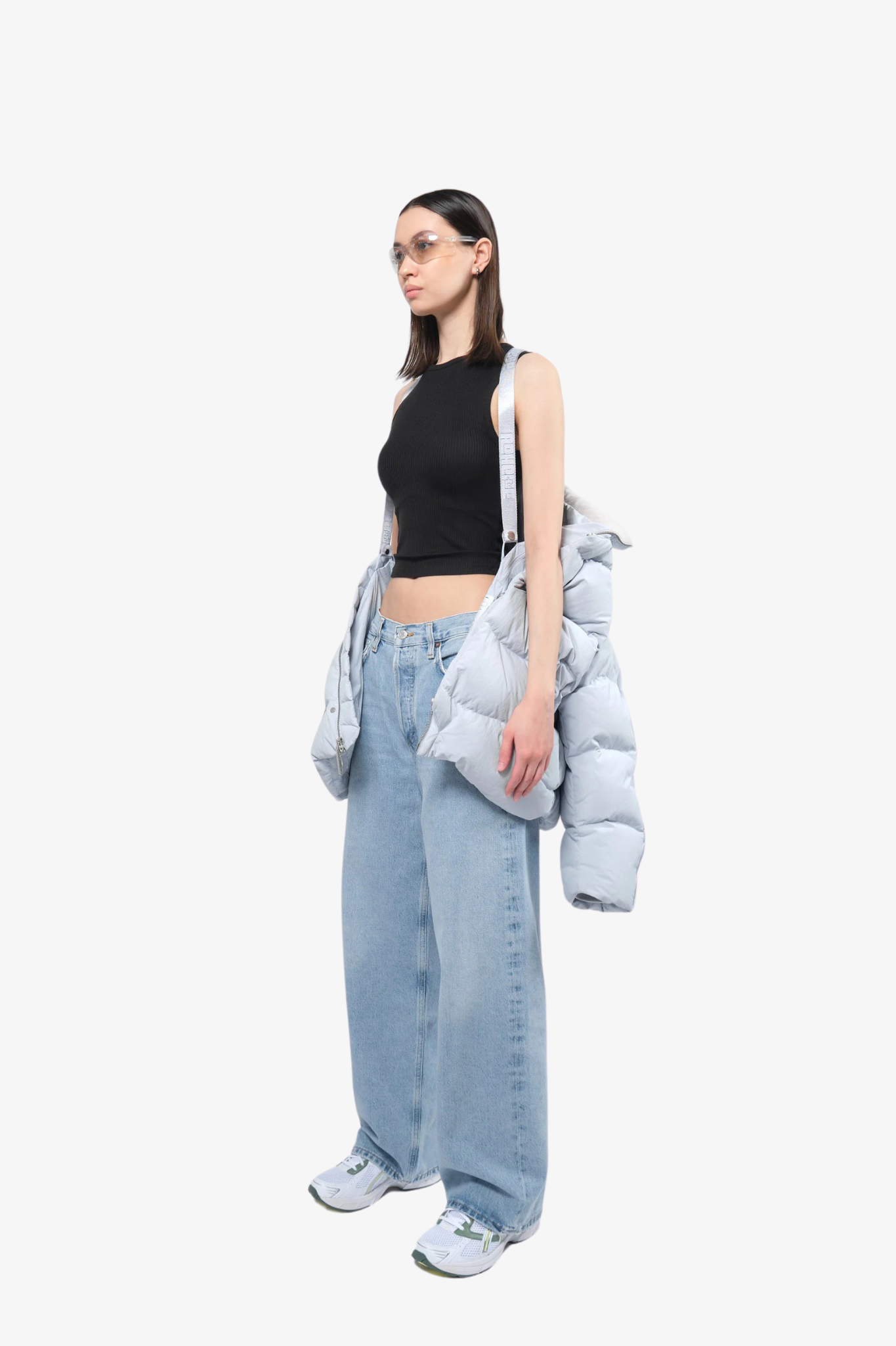 Model wearing a puffer jacket in a white background. 100% made from recycled fabric.