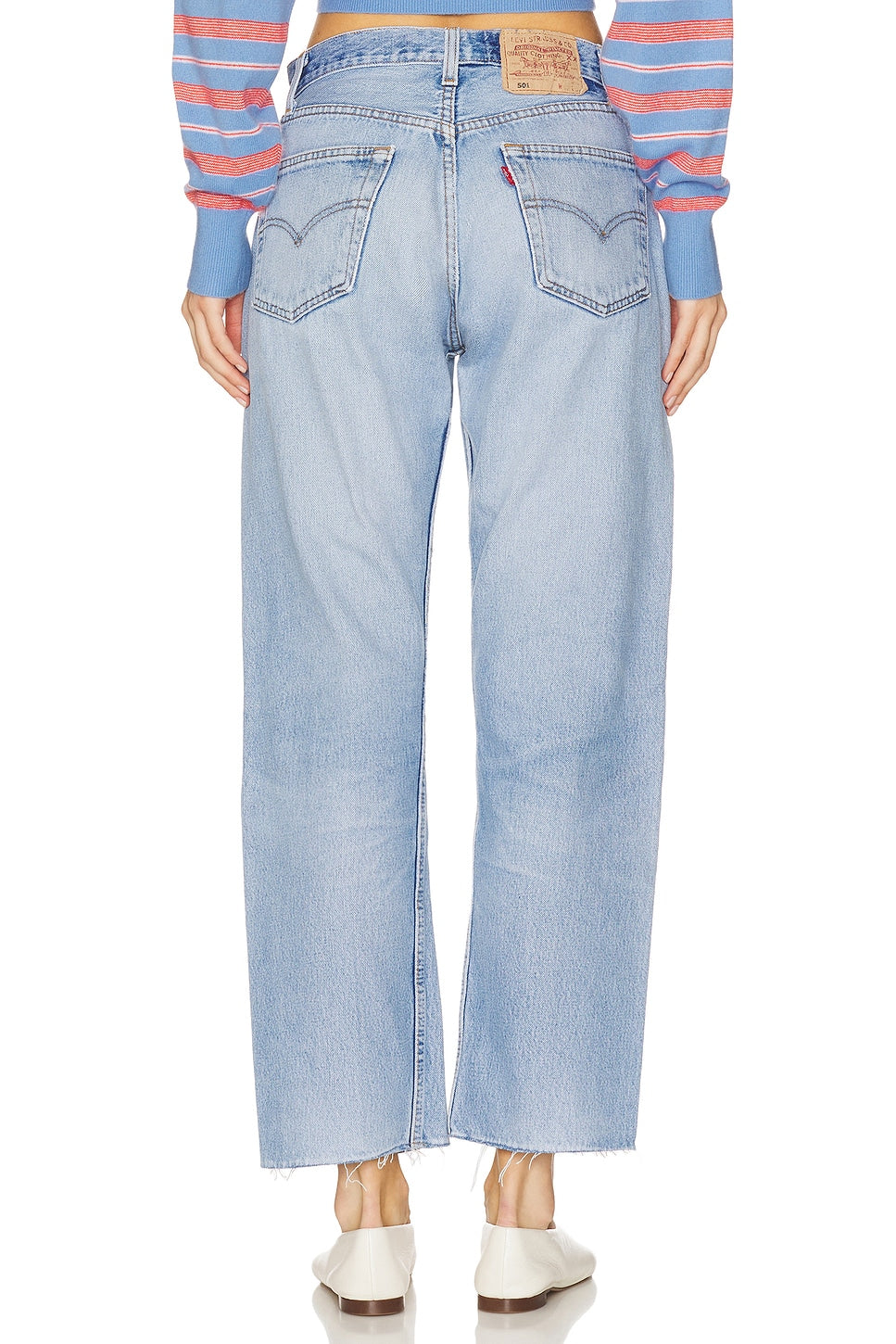 Model wearing the relax raw hem in a white background. 100% made from repurposed Levi’s.