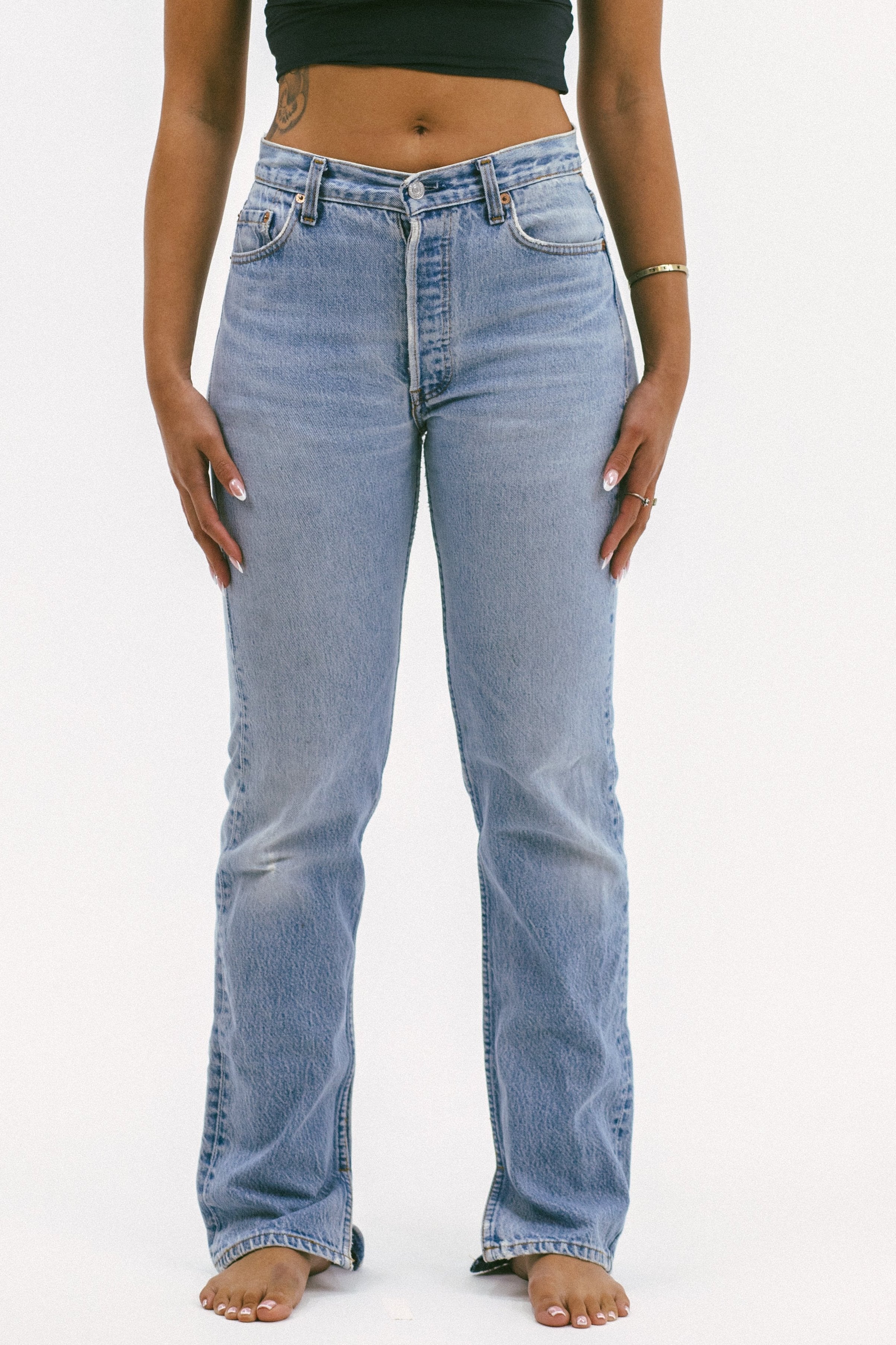 Model wearing the relaxed split in a white background. 100% made from repurposed Levi’s.
