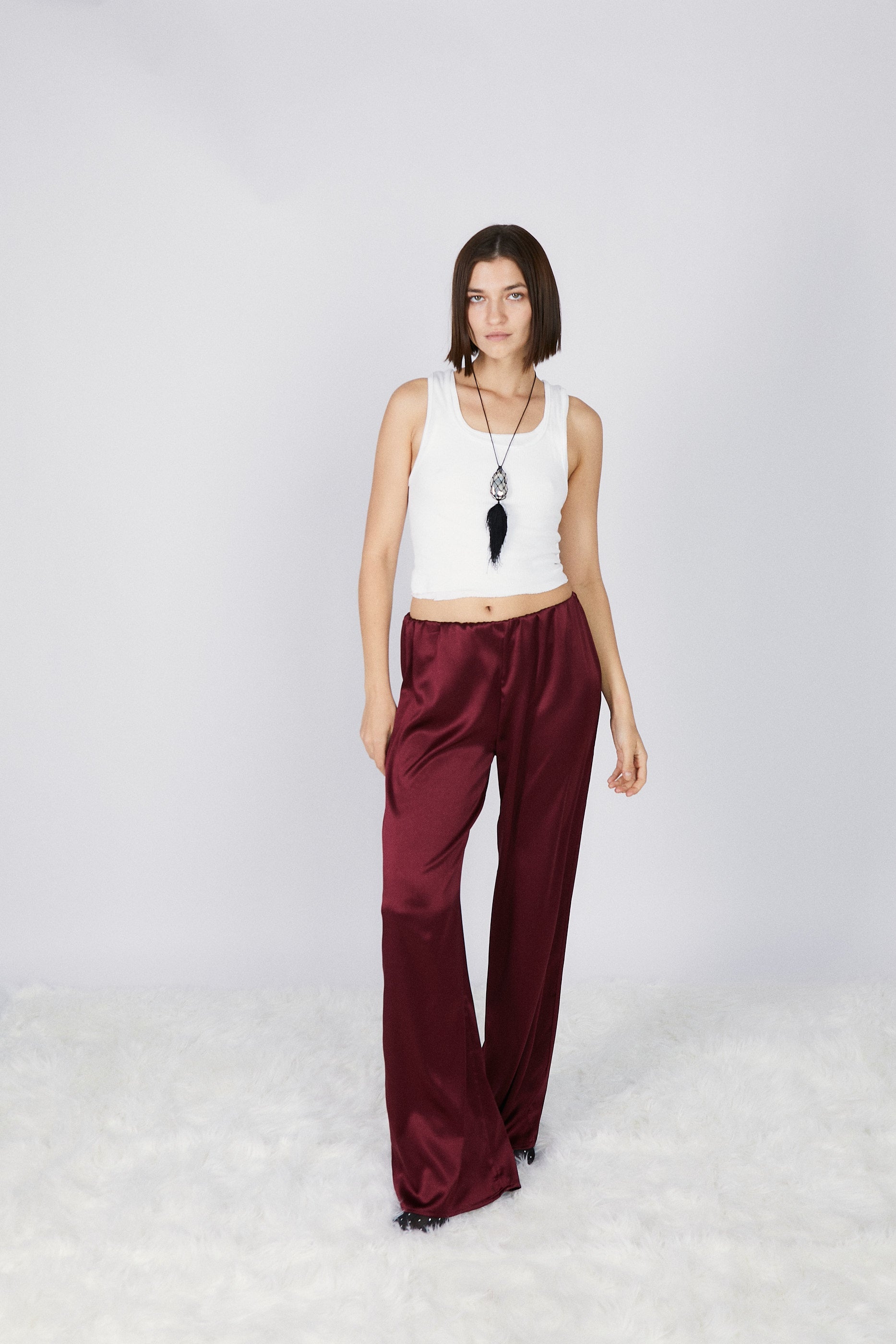 girl wearing roma silk pants in wine
