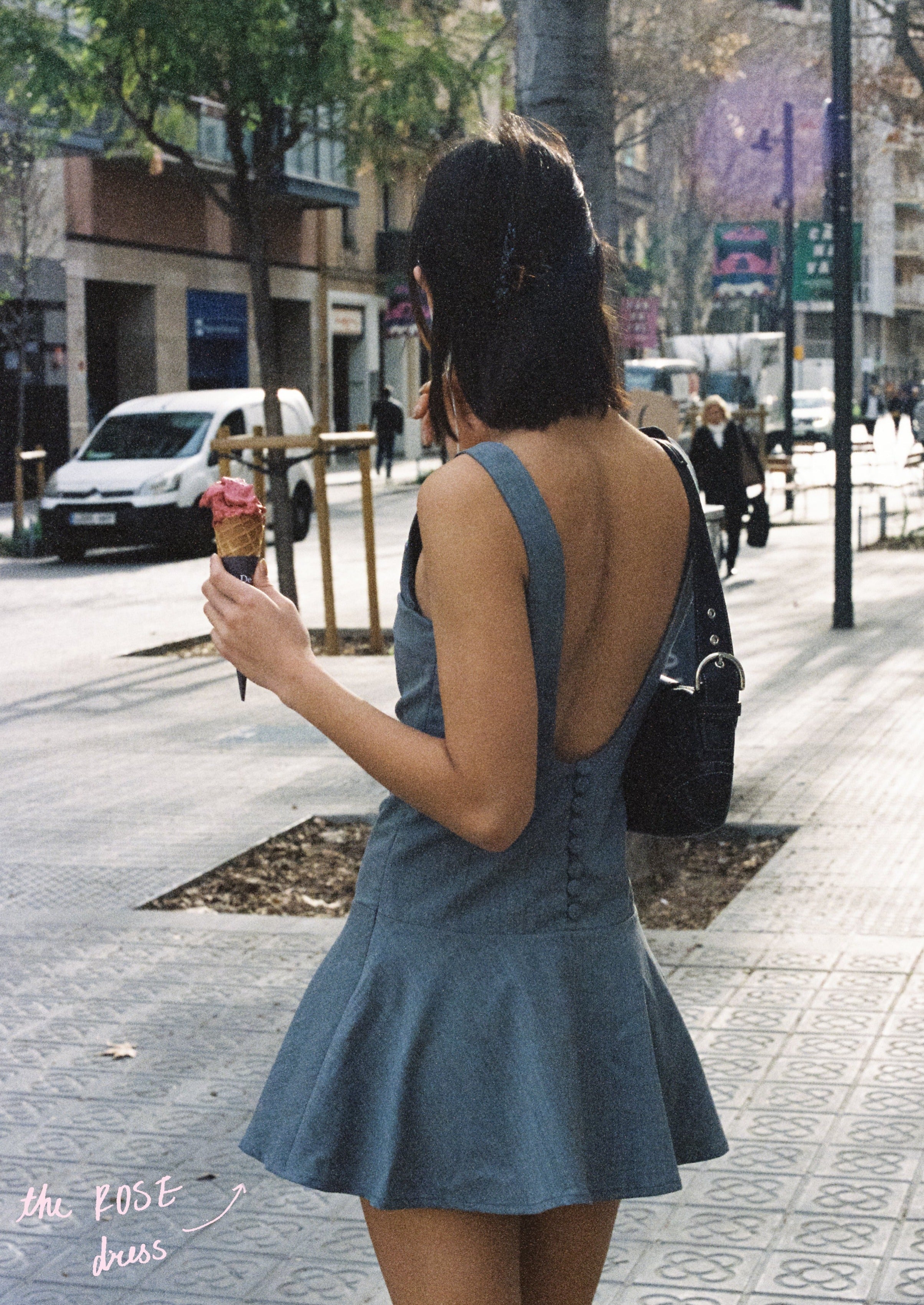 A model wearing the rose dress in an aesthetically background. 100% made from sustainable deadstock material.