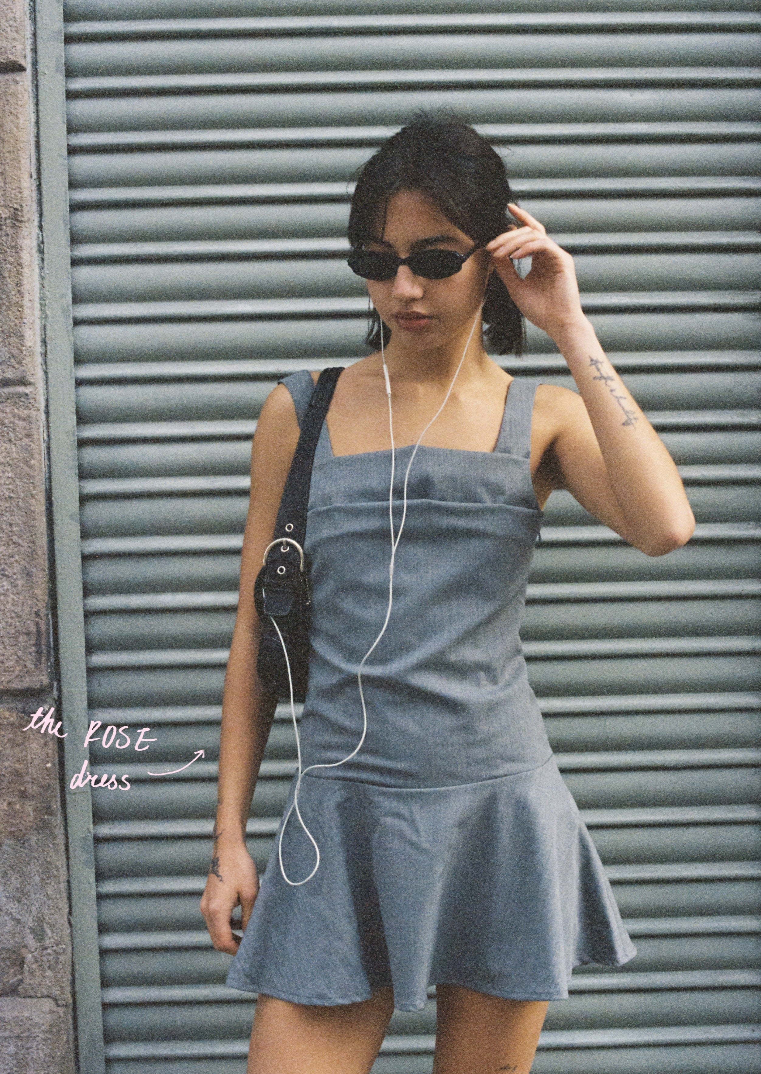 A model wearing the rose dress in an aesthetically background. 100% made from sustainable deadstock material.