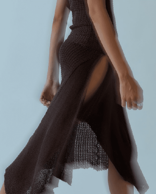 A model wearing the selene dress in a white background. 100% brown cotton knit.