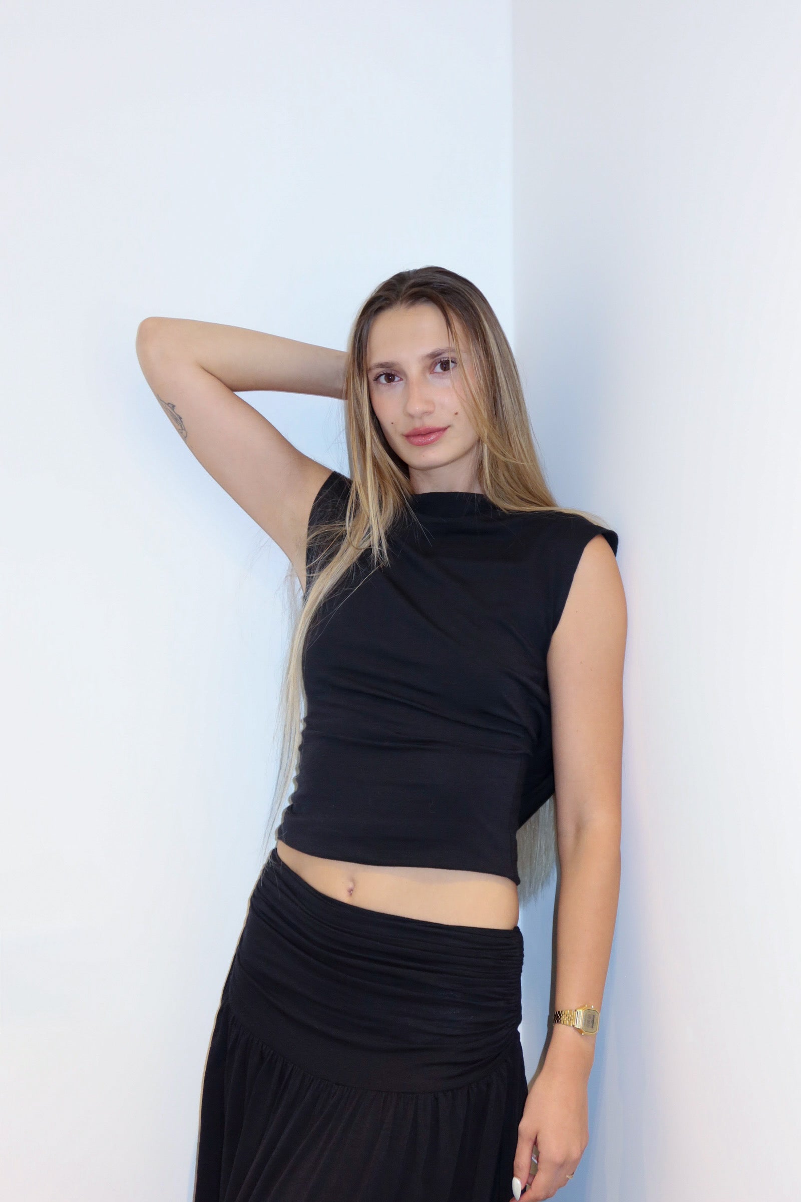 Model wearing the silk jersey top in a white background. 100% made from deadstock.