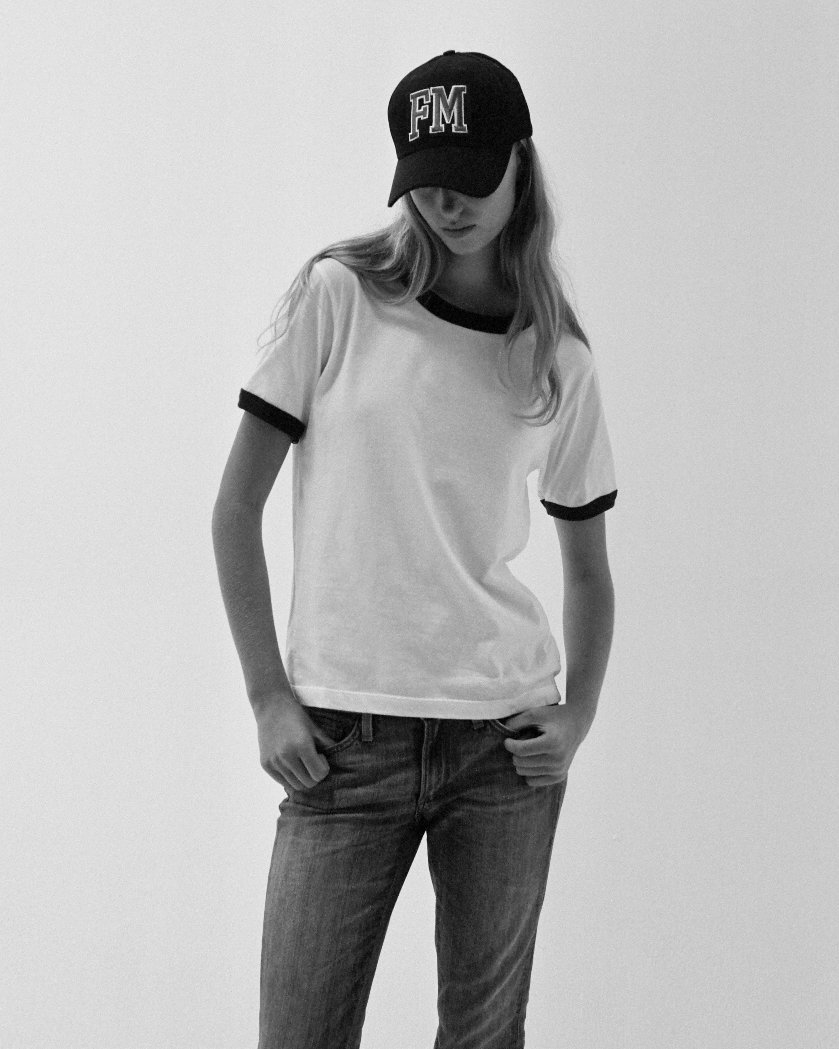 A model wearing the white/navy star ringer tshirt in a white background. 100% made from organic grown cotton.