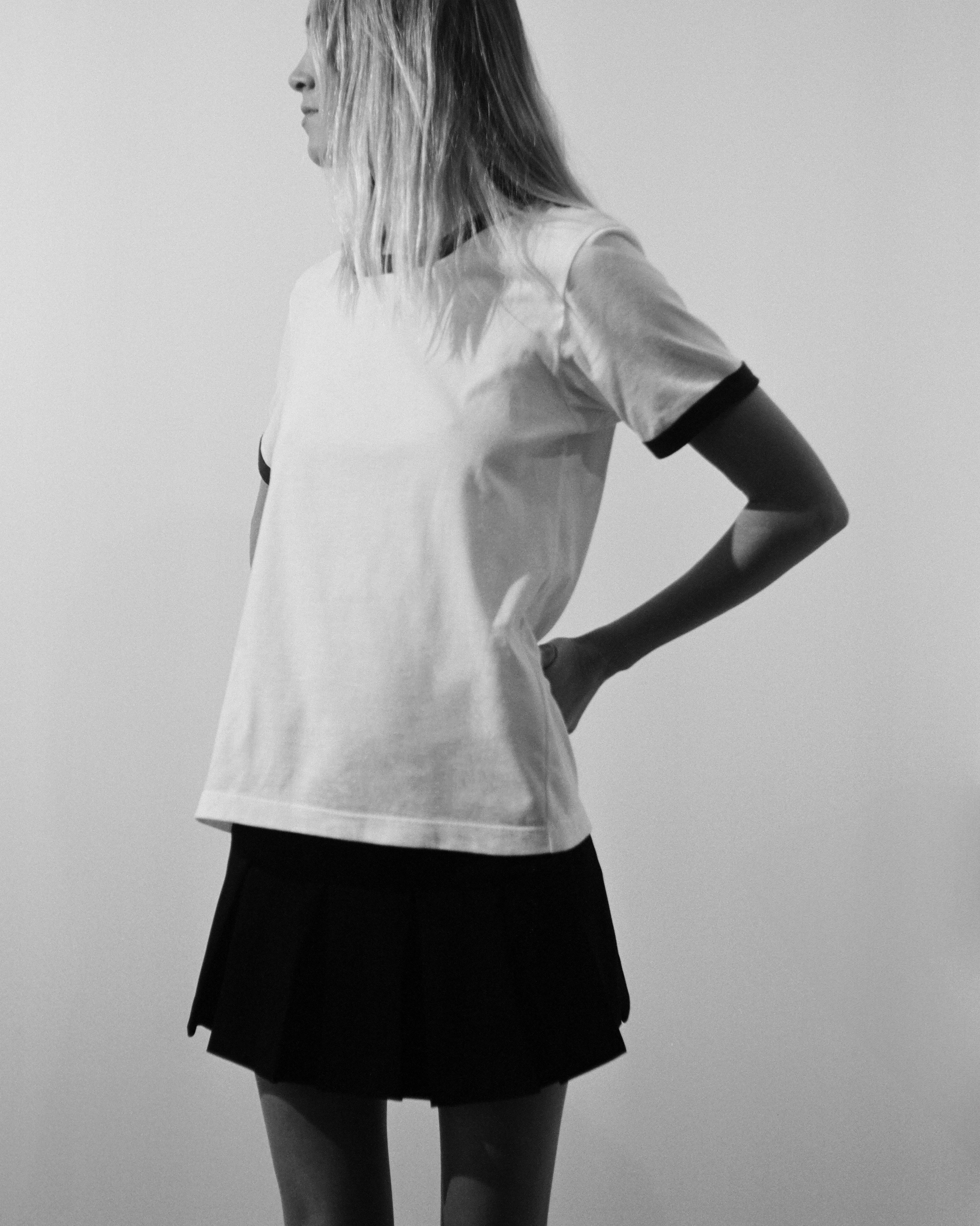 A model wearing the white/navy star ringer tshirt in a white background. 100% made from organic grown cotton.