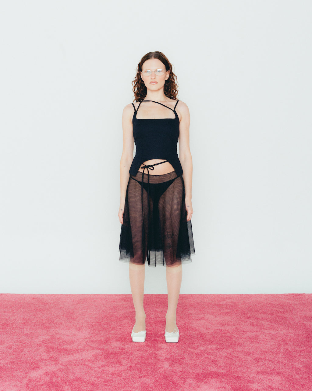 A model wearing the black u top in a white background. Heavyweight 100% Organic Cotton.