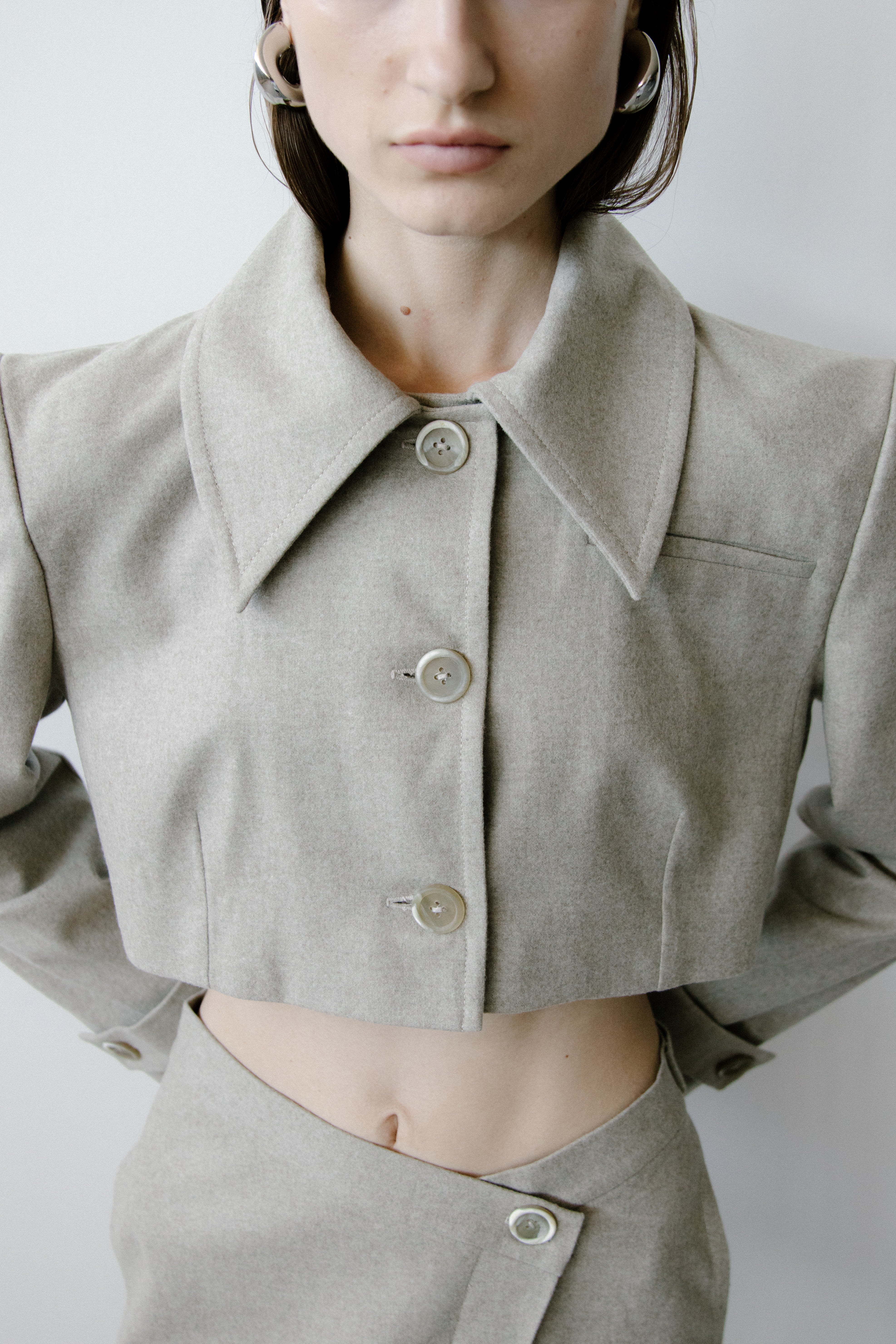 A model wearing the triangle taupe skirt in a white background. 100% made from organic cotton.