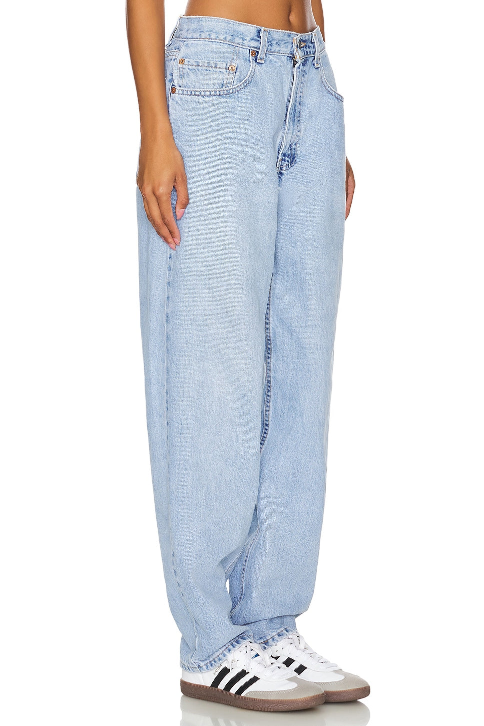 Model wearing an ultra baggy customs in a white background. 100% made from repurposed Levi’s.