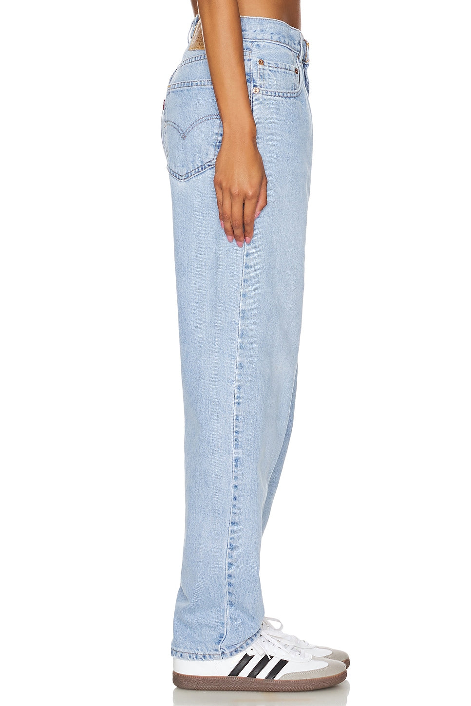 Model wearing an ultra baggy customs in a white background. 100% made from repurposed Levi’s.