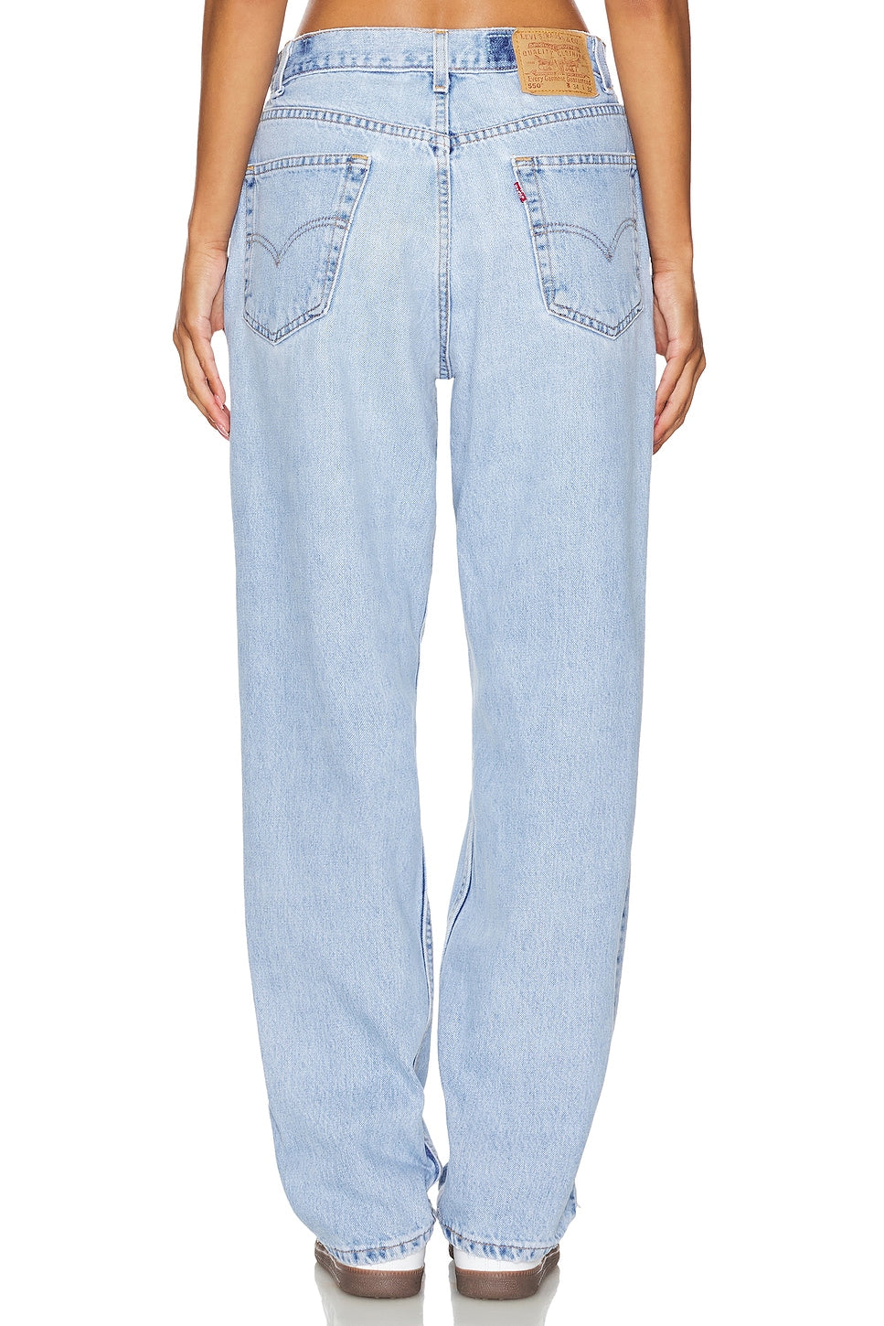 Model wearing an ultra baggy customs in a white background. 100% made from repurposed Levi’s.