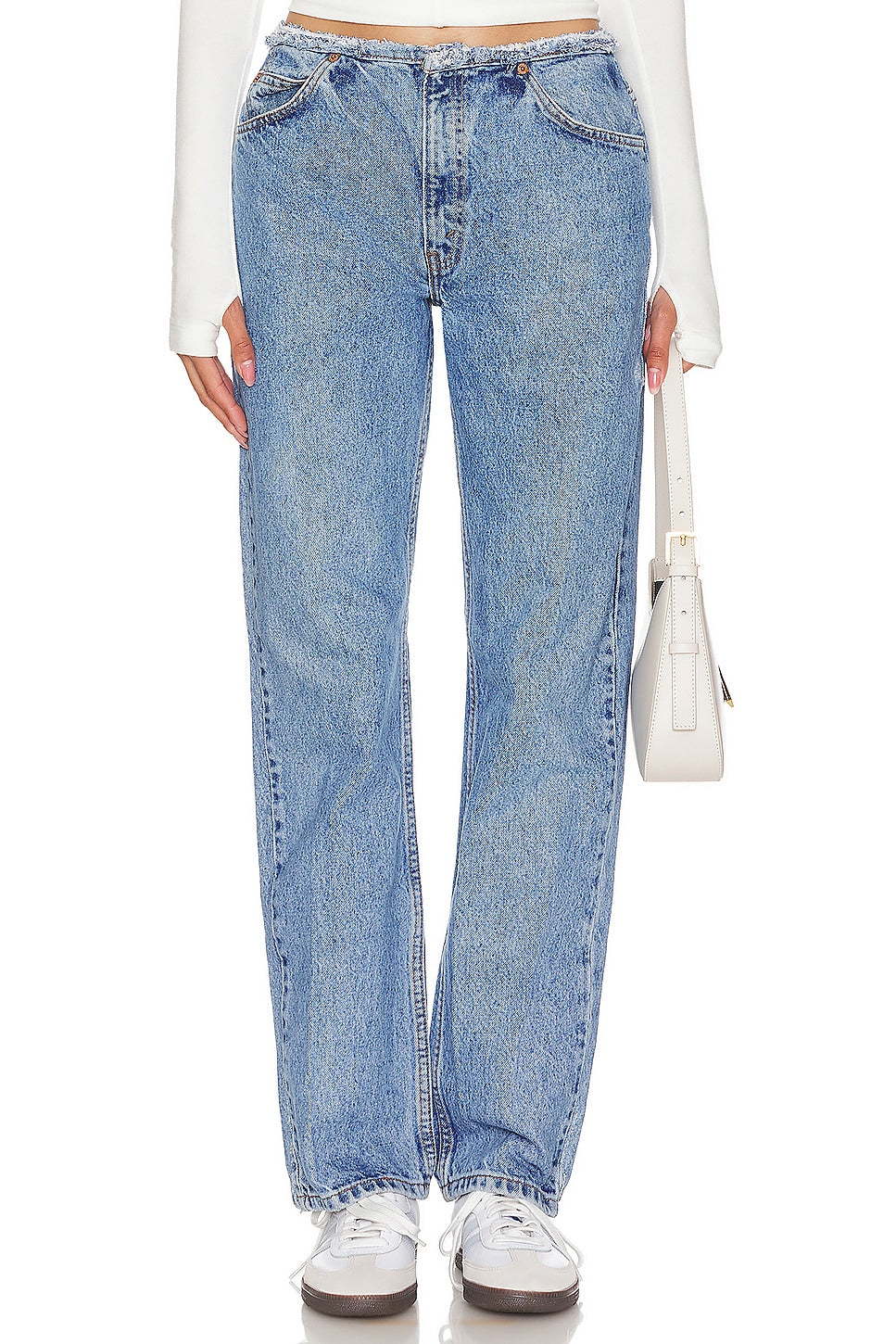 Model wearing an undone mini rise customs in a white background. 100% made from repurposed Levi’s.