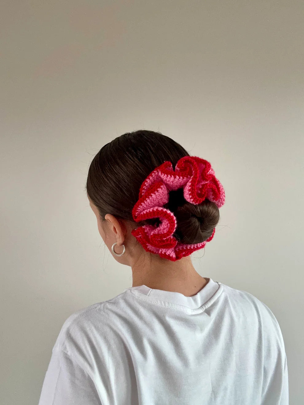 A model wearing the azaryiah scrunchie in a white background. Handmade in London!