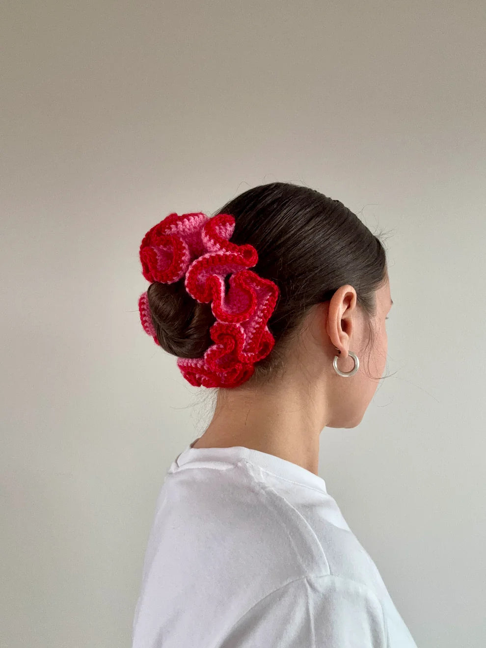 A model wearing the azaryiah scrunchie in a white background. Handmade in London!