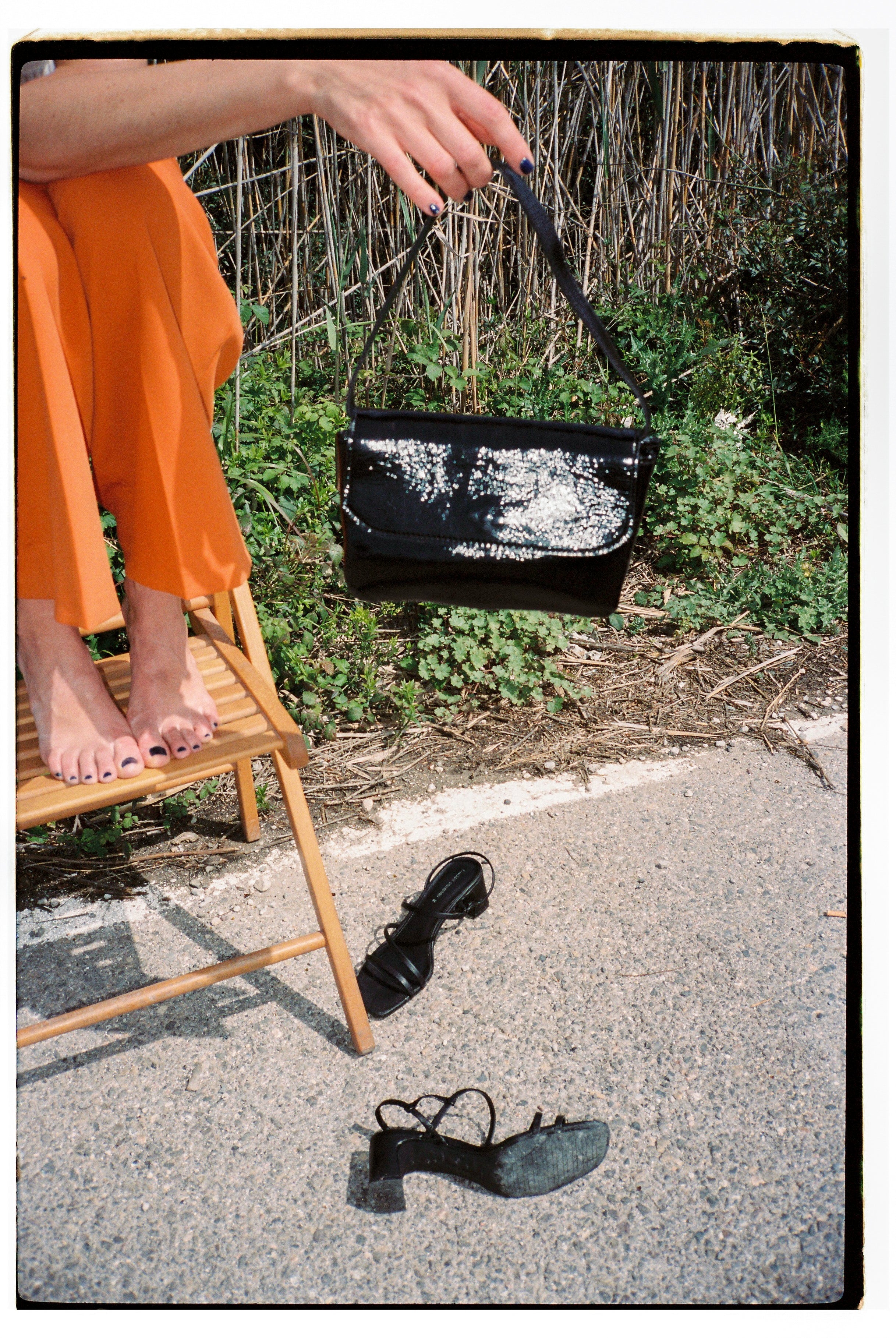 A model wearing the babe black bag in an aesthetically background. 100% made from deadstock leather.