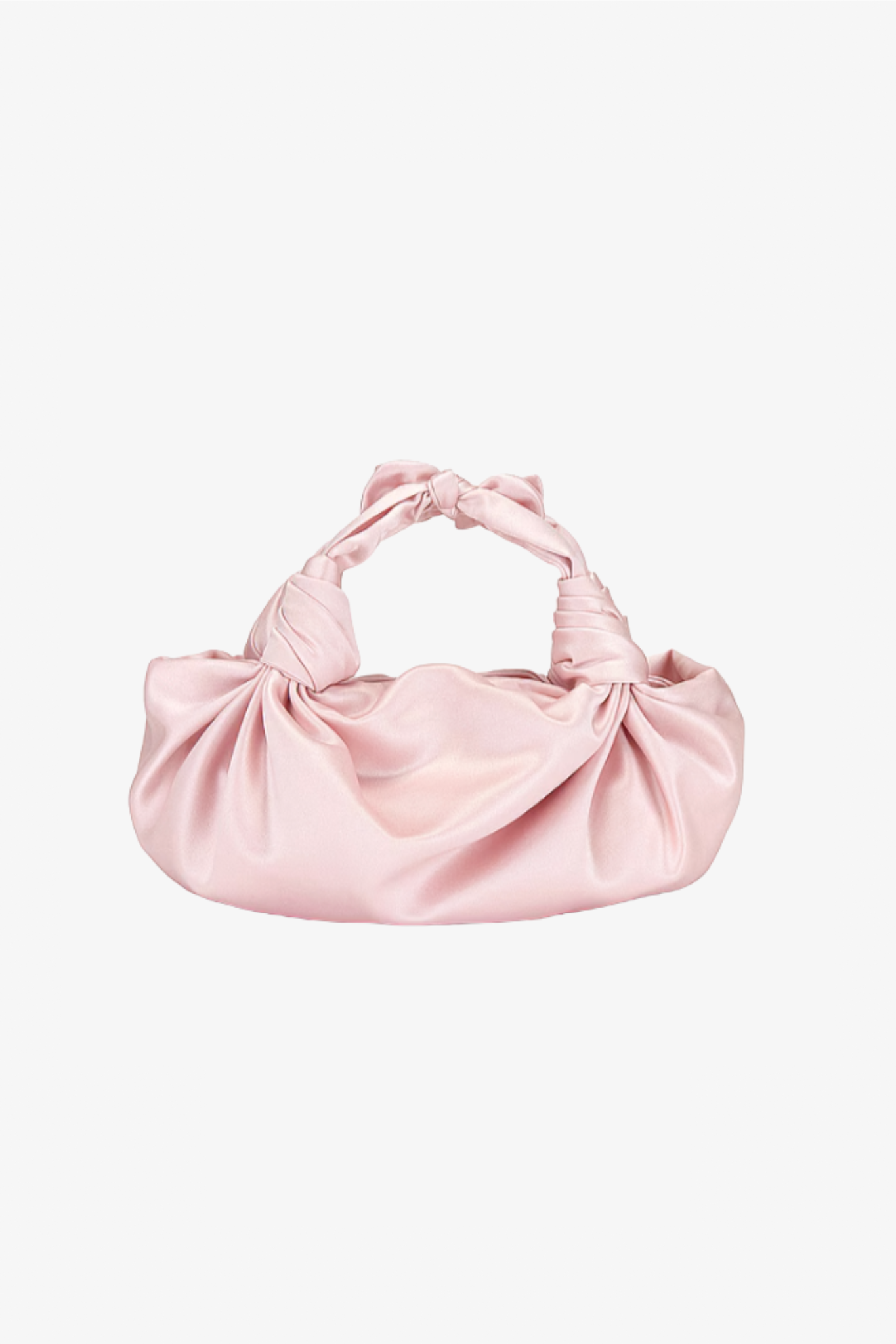 The blush silk knot bag in a white background. Deadstock silky satin fabric sourced in Los Angeles.