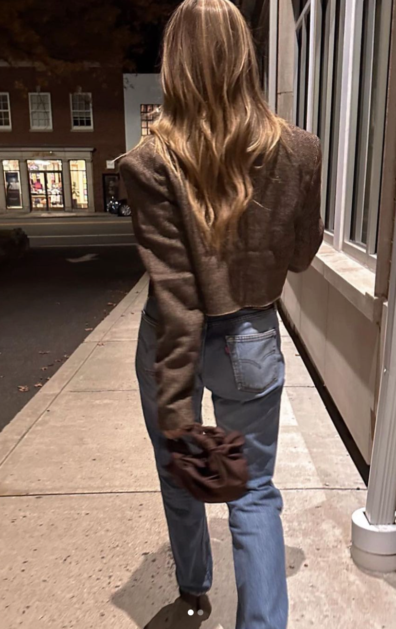 A model wearing the chocolate silk knot bag. Deadstock silky satin fabric sourced in Los Angeles.