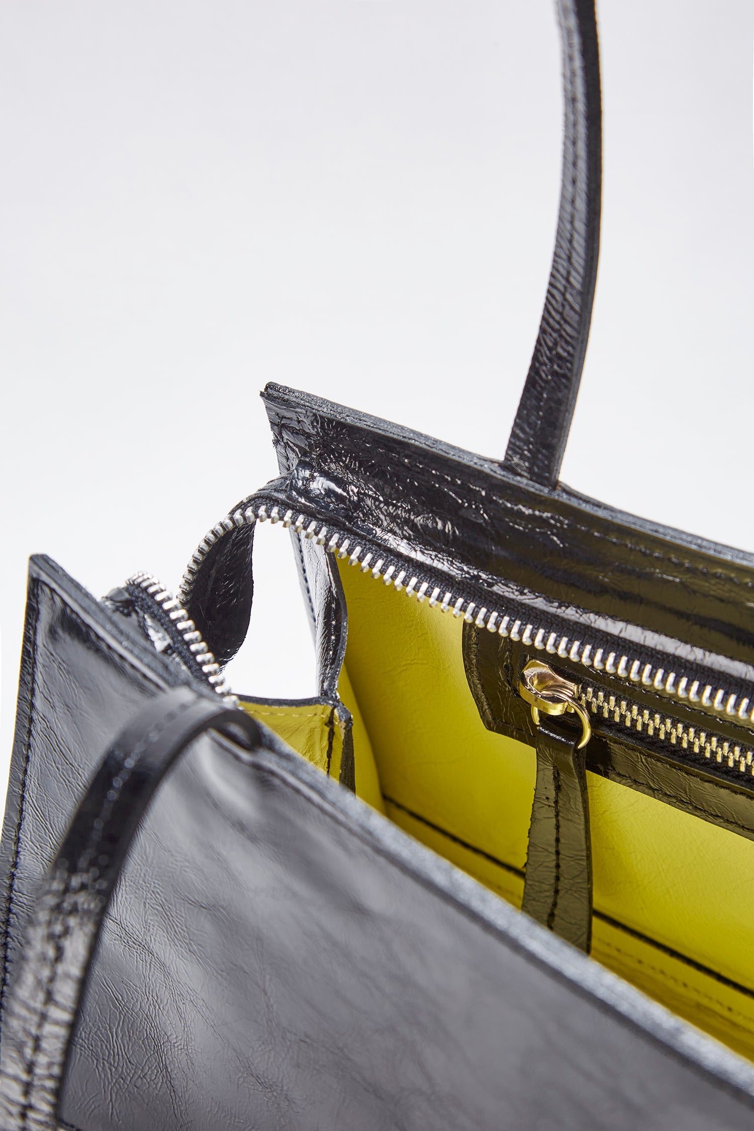 Close-up of the hotdog black wrinkle bag in a white background. 100% made from deadstock leather.