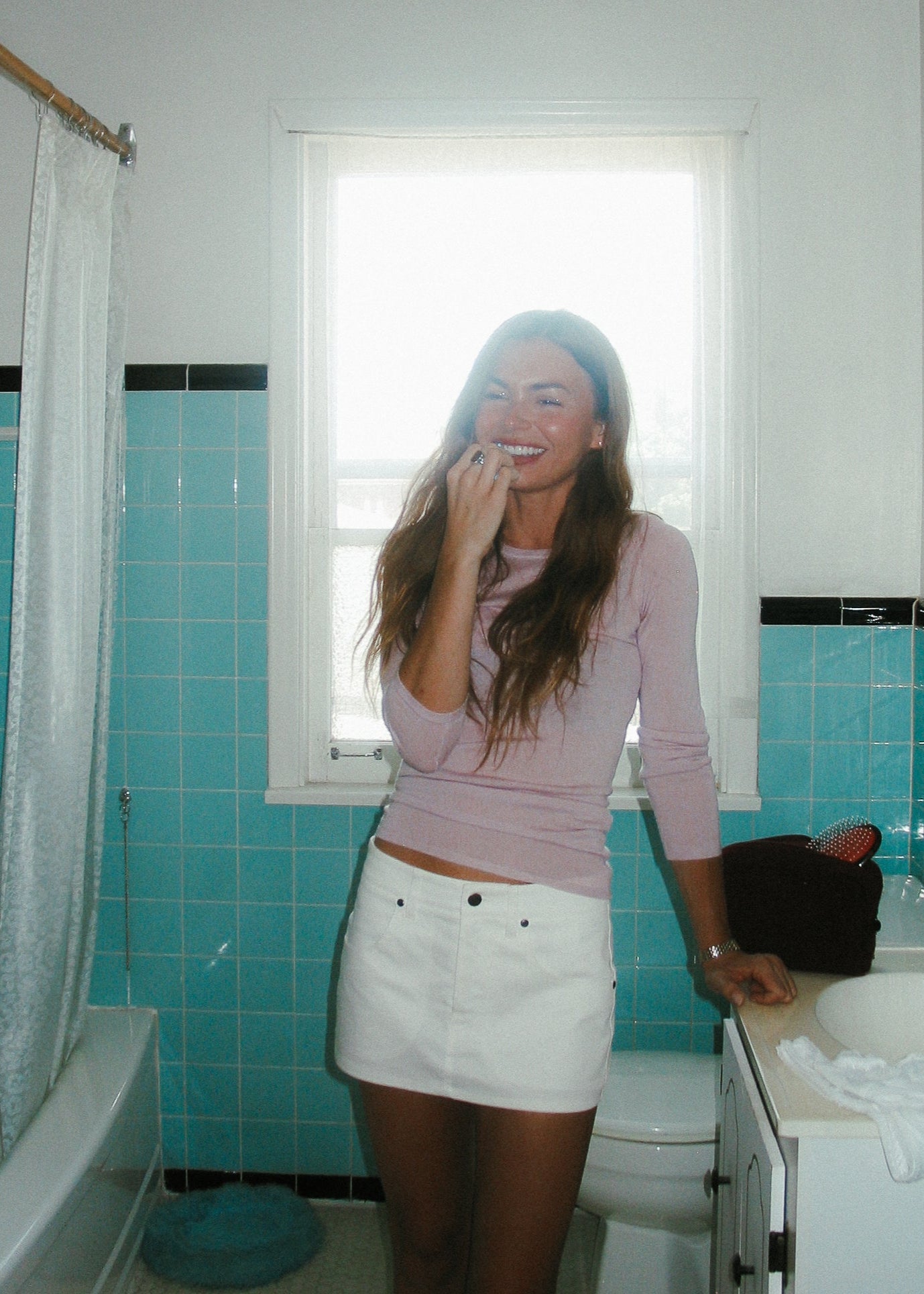 A model wearing the long sleeve in a bathroom background. Sustainably made from breathable wool–silk blend