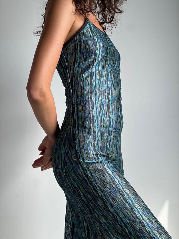 A model wearing the green naomi dress in a white background. 100% deadstock Missoni-like, polyester knit blend. CLOSE-UP
