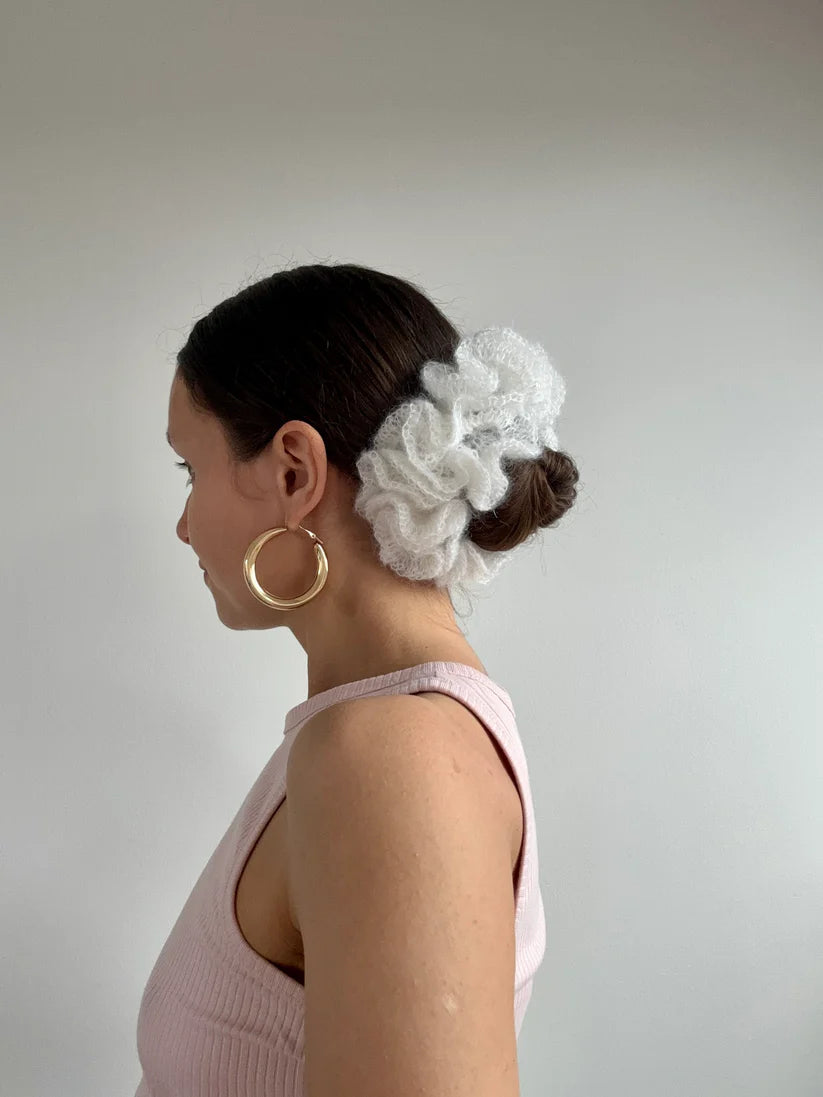 A model wearing the anna scrunchie in a white background. Handmade in London!