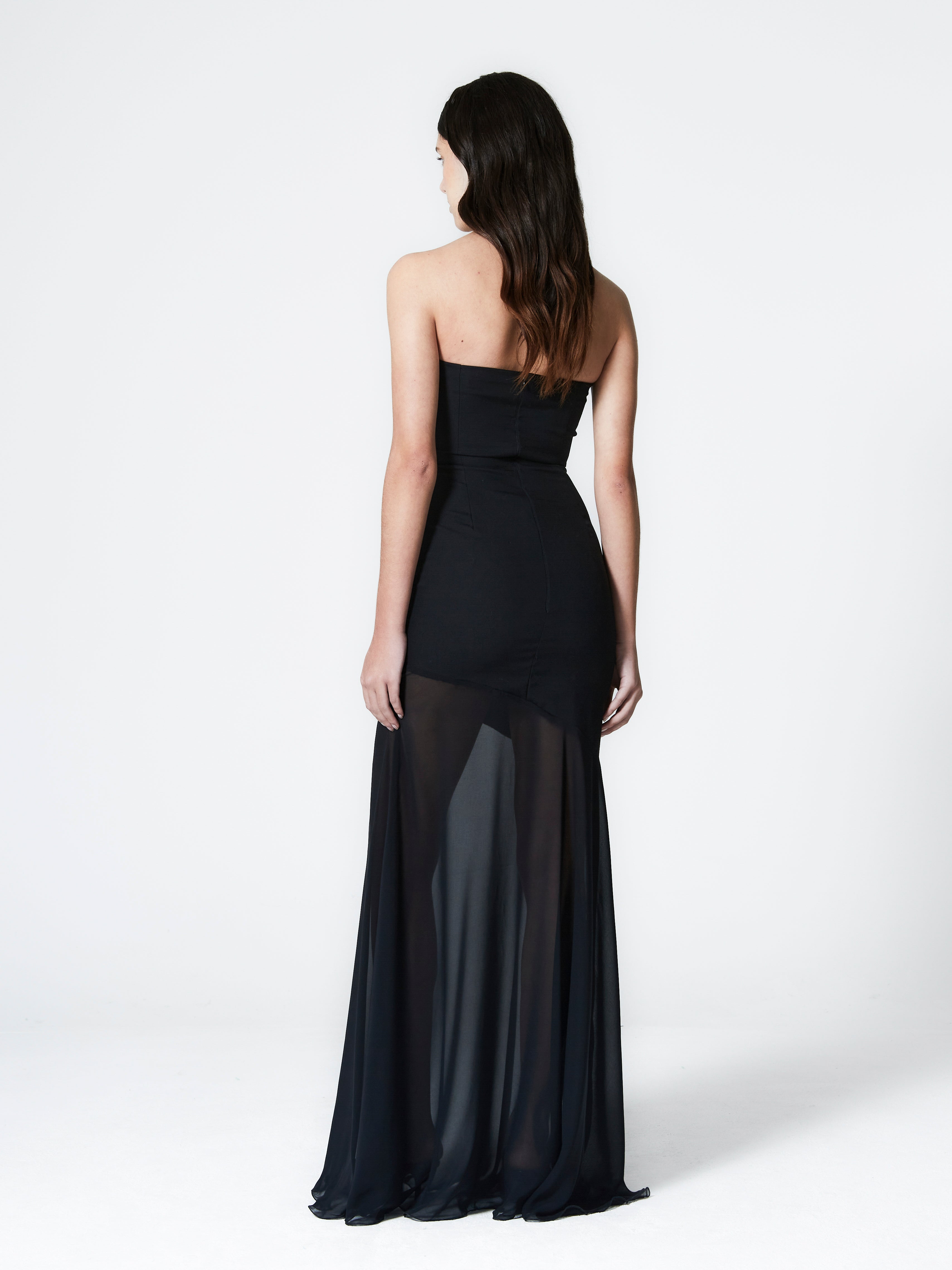 A model wearing the aria gown in a white background. Made from deadstock wool paired with deadstock soft sheer viscose chiffon