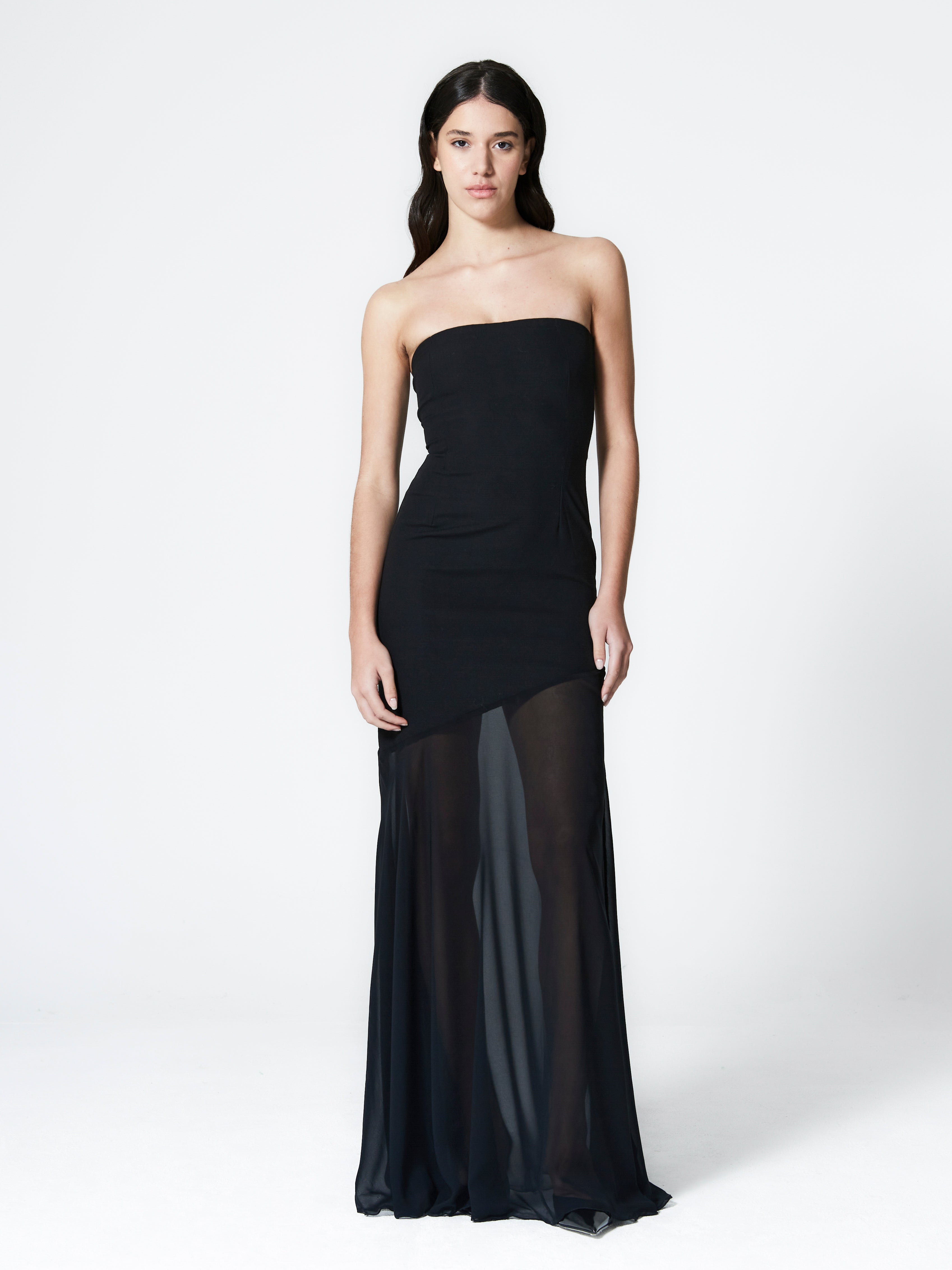 A model wearing the aria gown in a white background. Made from deadstock wool paired with deadstock soft sheer viscose chiffon