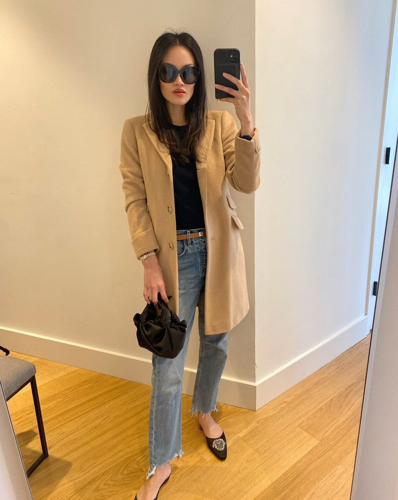 A model wearing the black silk knot bag. Deadstock silky satin fabric sourced in Los Angeles.