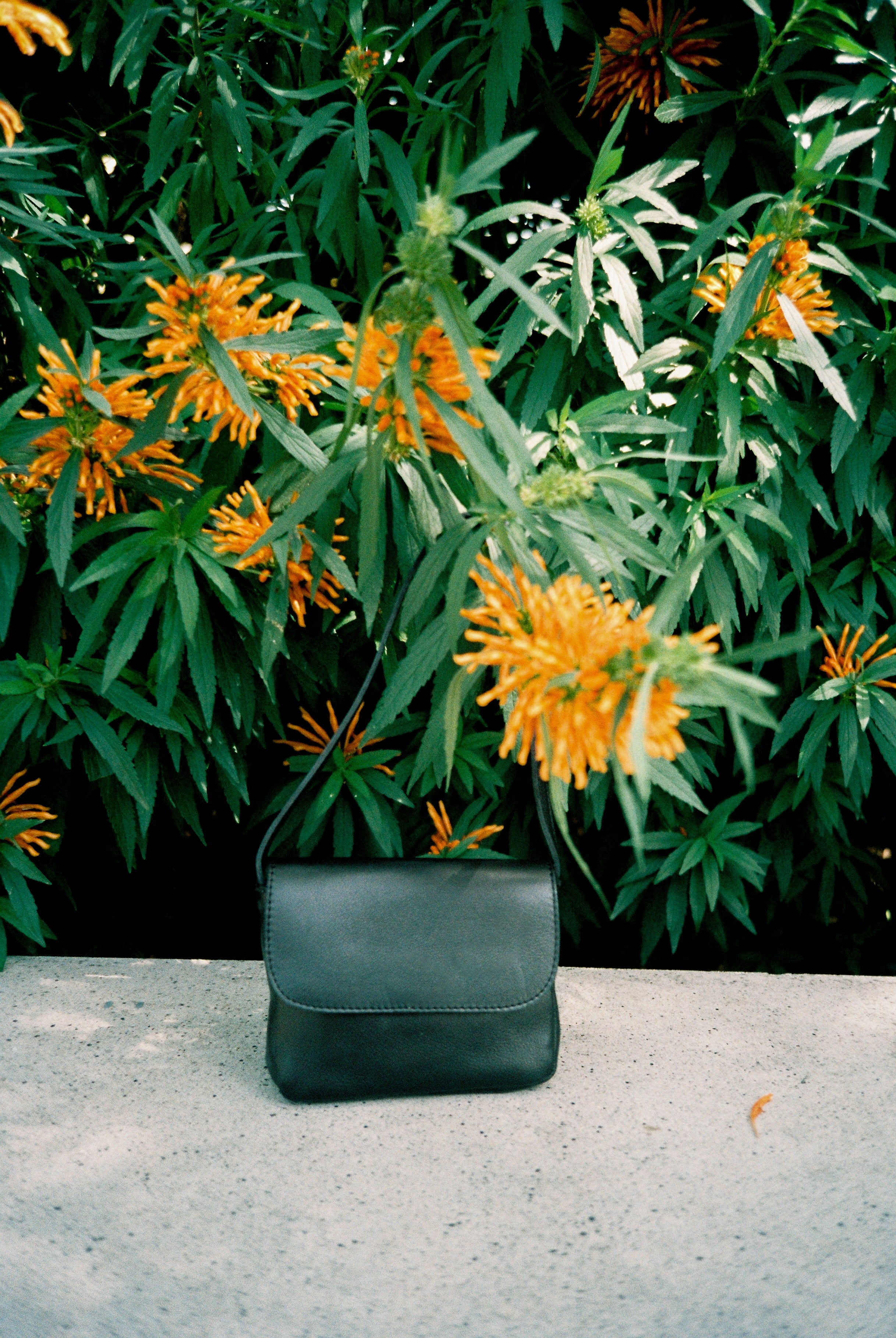 The baby black matte bag in an aesthetically background. 100% made from deadstock leather.
