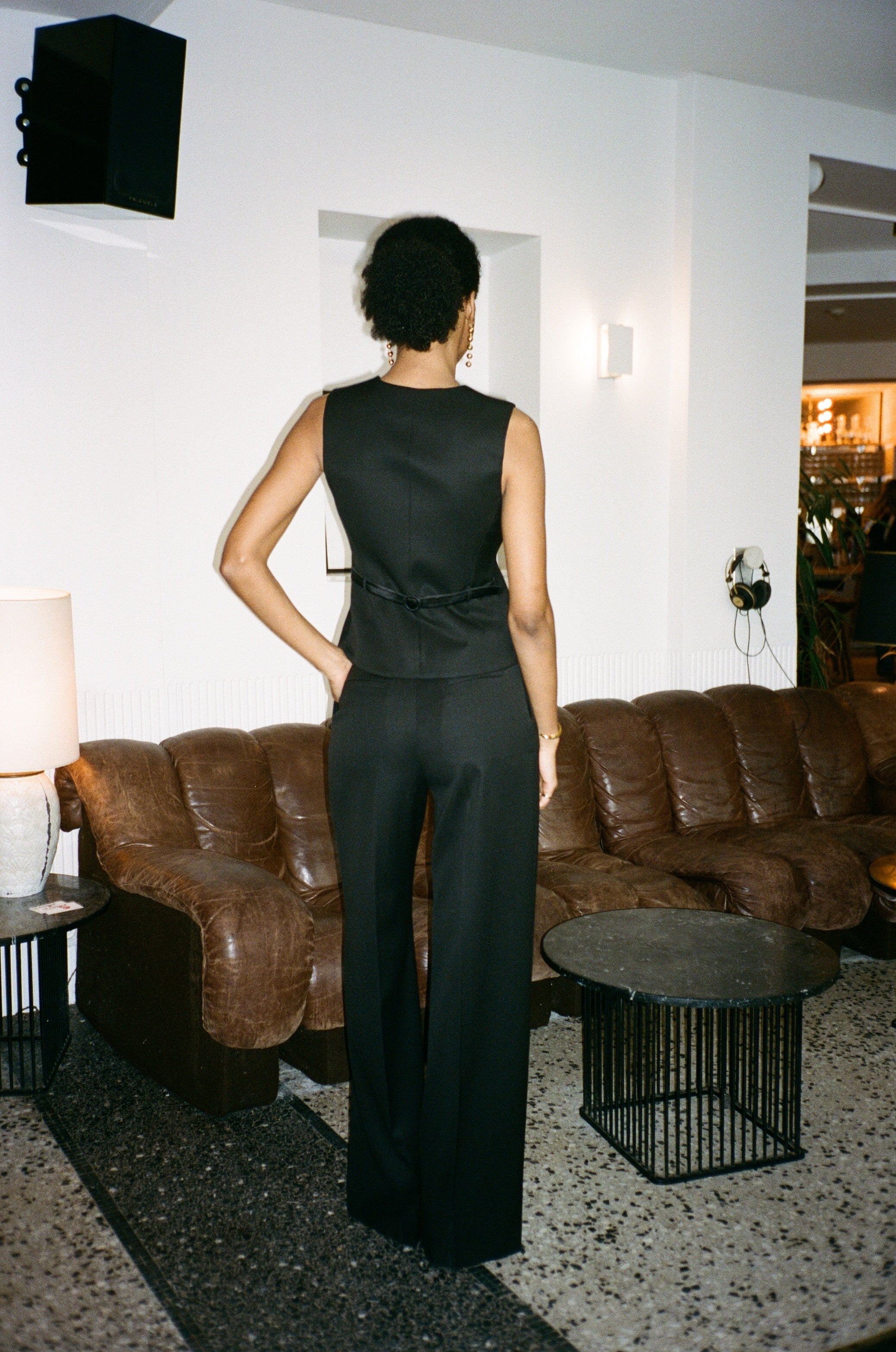 A model wearing the bianca wool and satin smoking pants in an aesthetically background. 100% upcycled wool and silk mix.