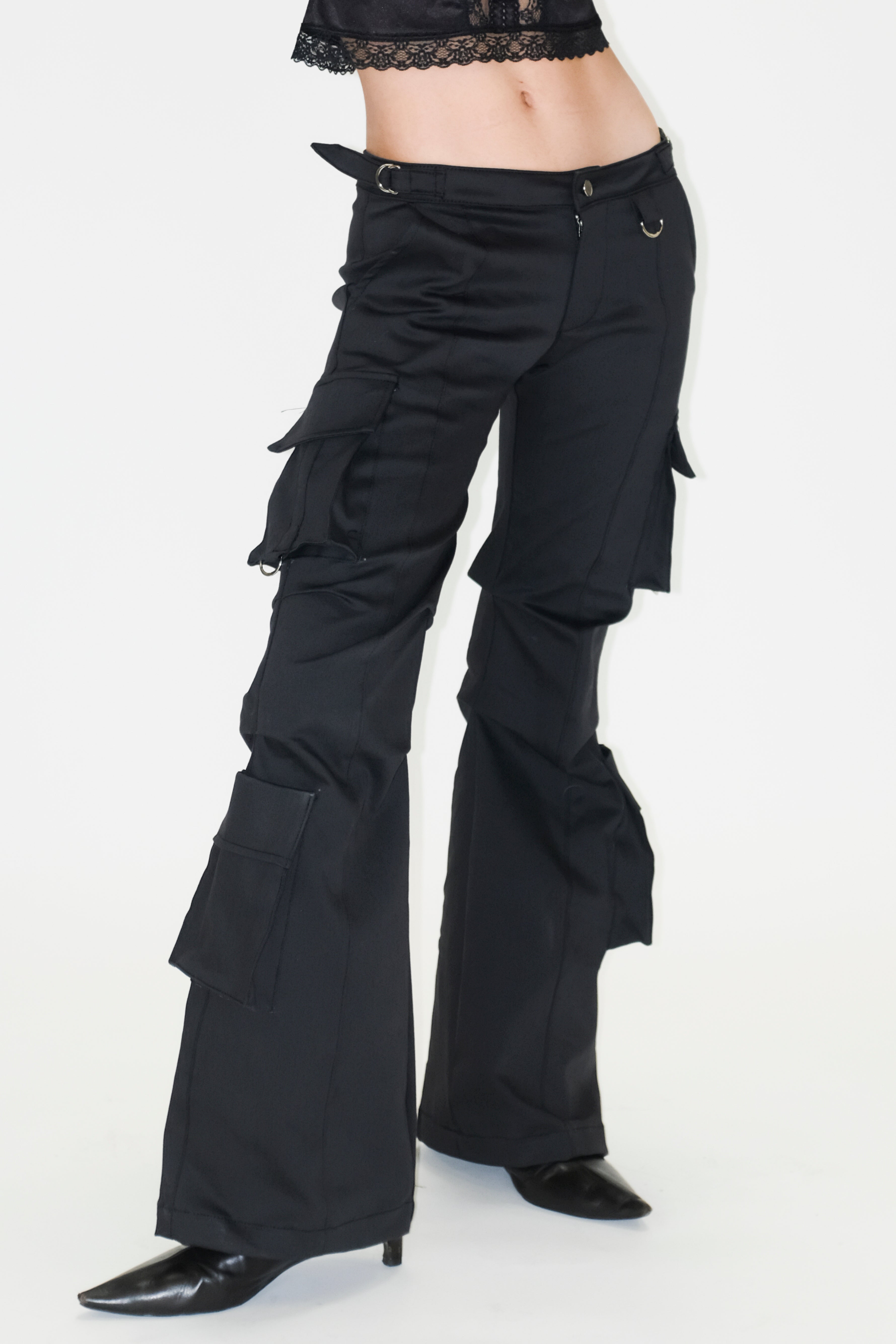 A model wearing the bootcut cargo pants in a white background. 100% deadstock, in a breathable cotton-poly twill.