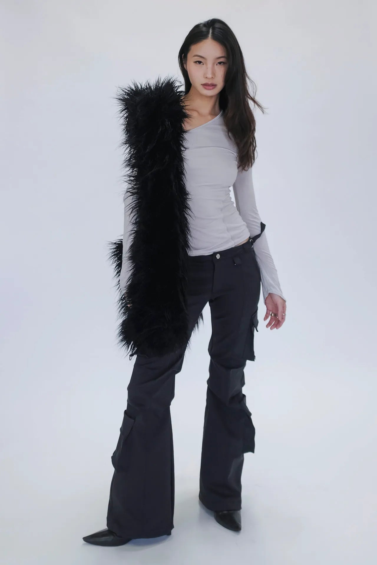 A model wearing the bootcut cargo pants in a white background. 100% deadstock, in a breathable cotton-poly twill.