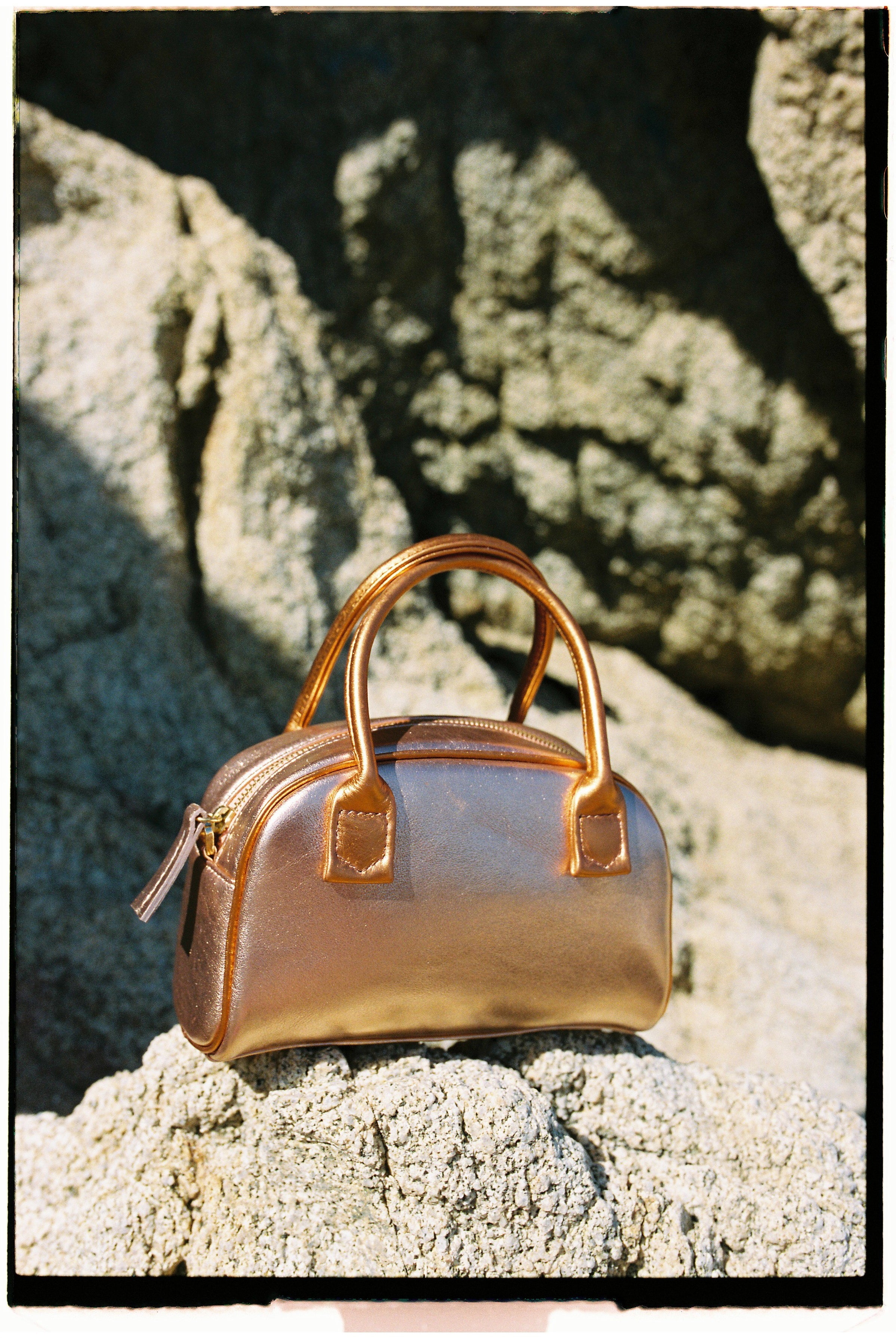 The bowling tropico bag in an aesthetically background. 100% made from deadstock leather.