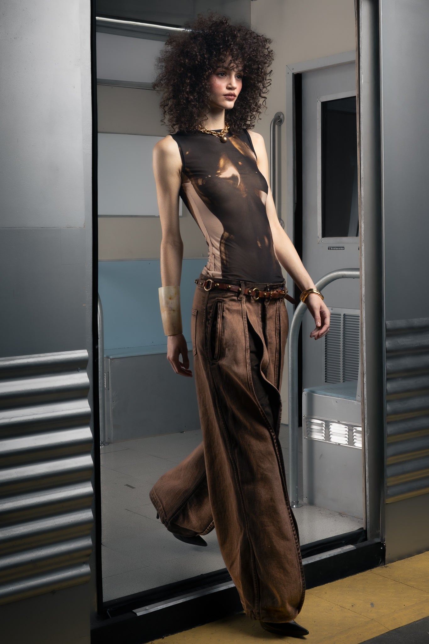 Woman in a stylish sustainable outfit standing in a futuristic or sci-fi setting.
