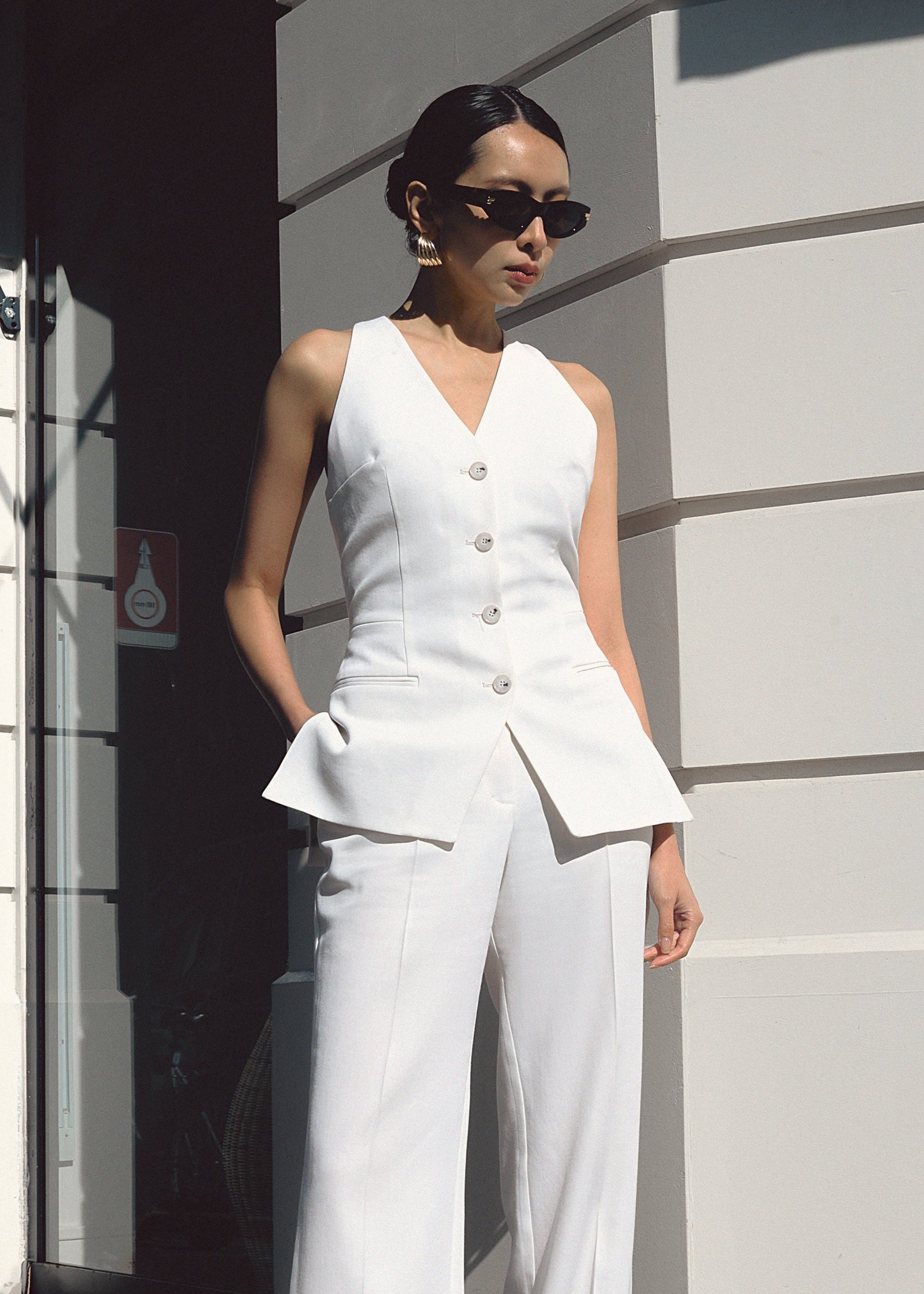 A model wearing the chelsea top in an aesthetically background.  100% sustainable Italian Wool.