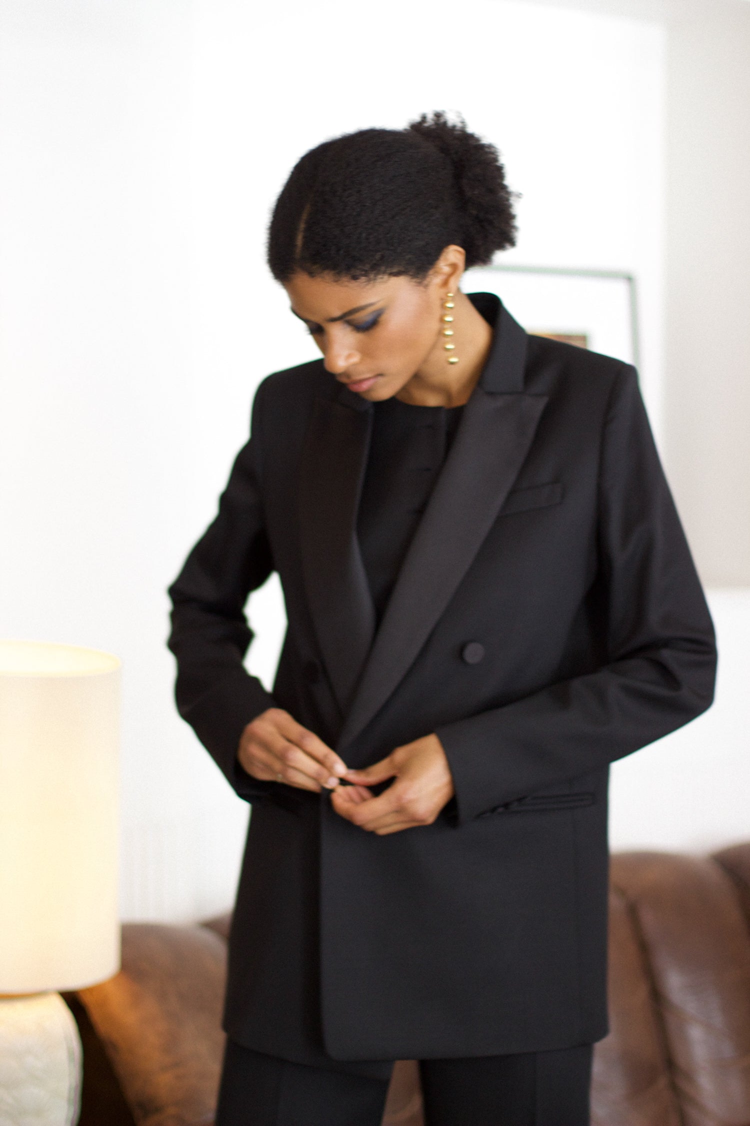 A model wearing the christy wool jacket with black satin collar in an aesthetically background. 100% made from upcycled wool and satin. 