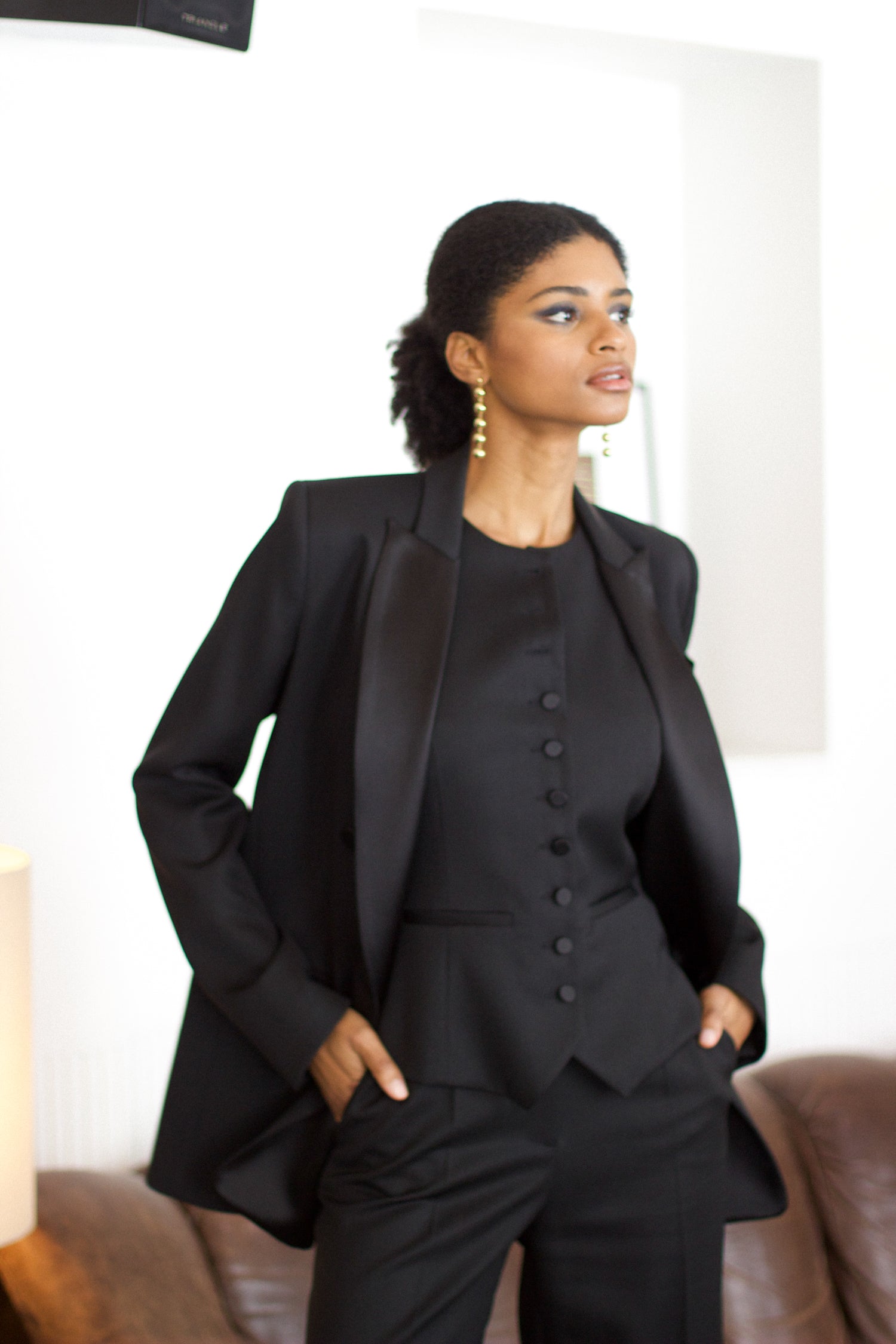 A model wearing the christy wool jacket with black satin collar in an aesthetically background. 100% made from upcycled wool and satin. 