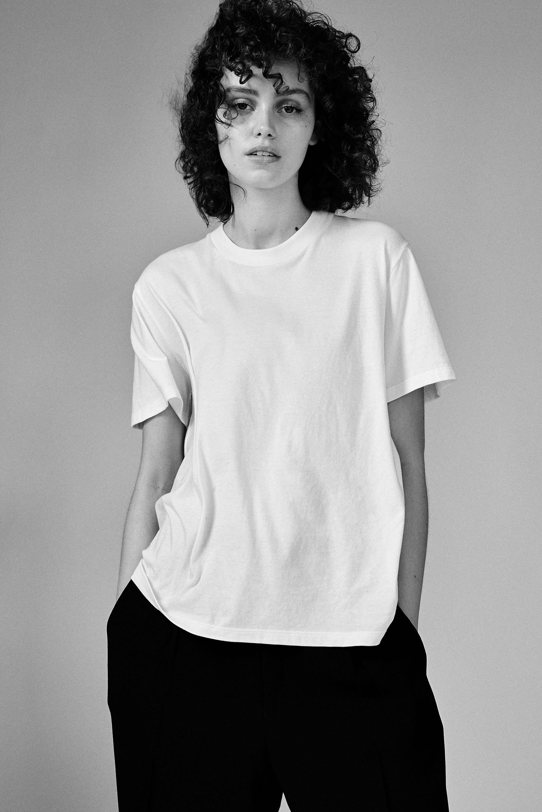 A model wearing the white classic tee in a white background. 100% made from organic grown cotton. 