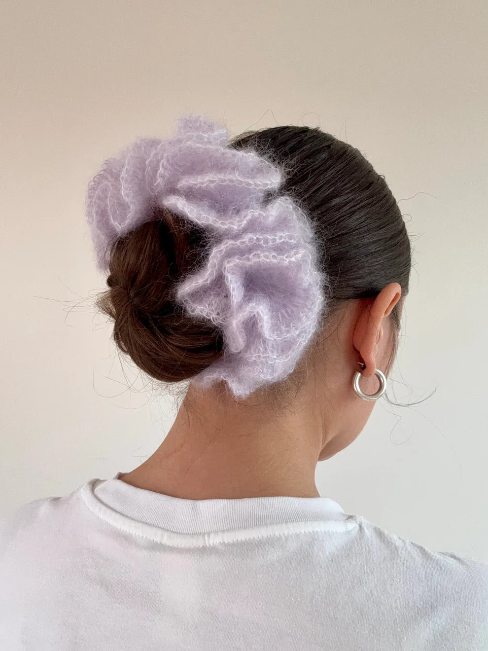 A model wearing the cleo scrunchie in a white background. Handmade in London!