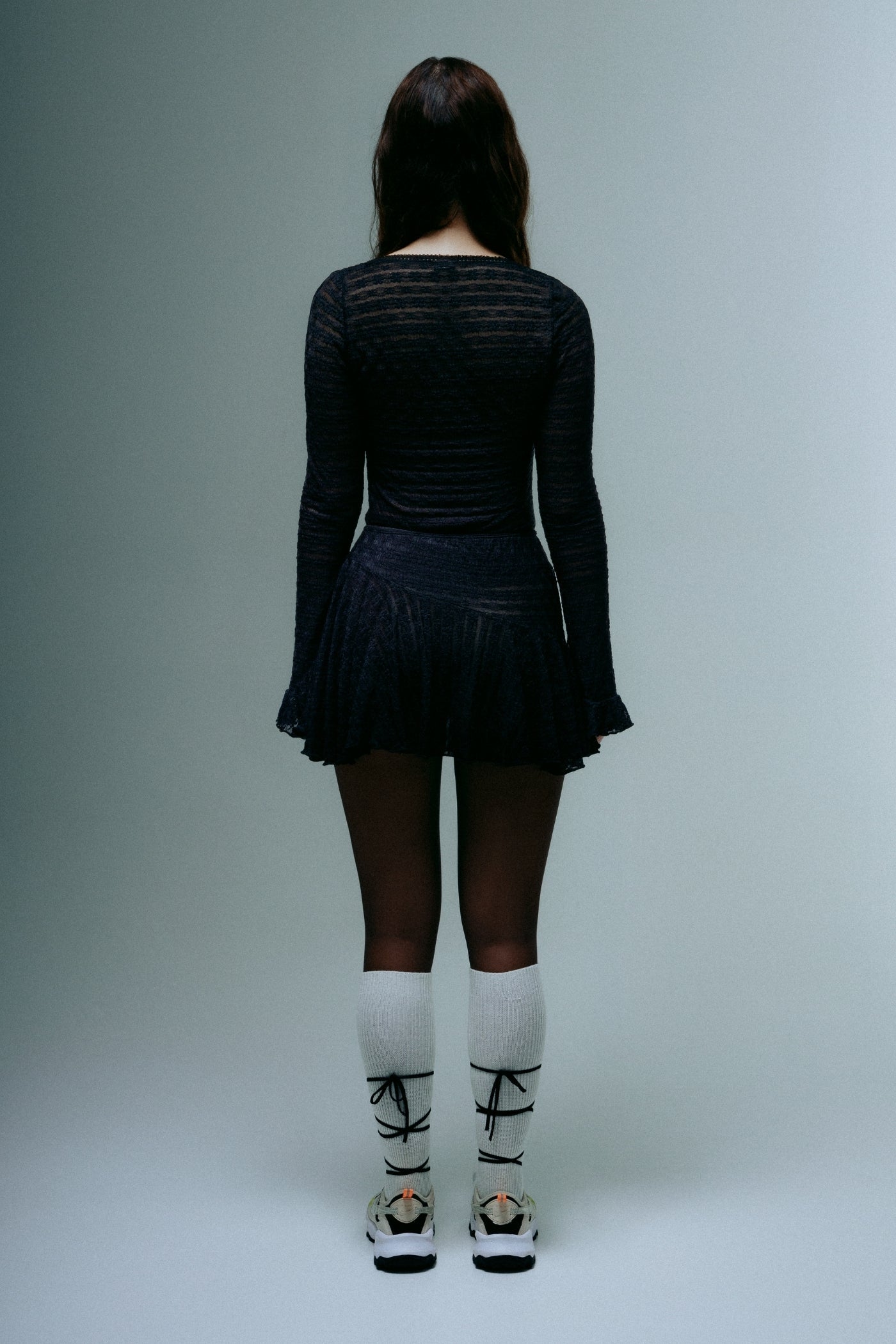 A model wearing the dreamlace top in a white background. 100% deadstock lace material. 