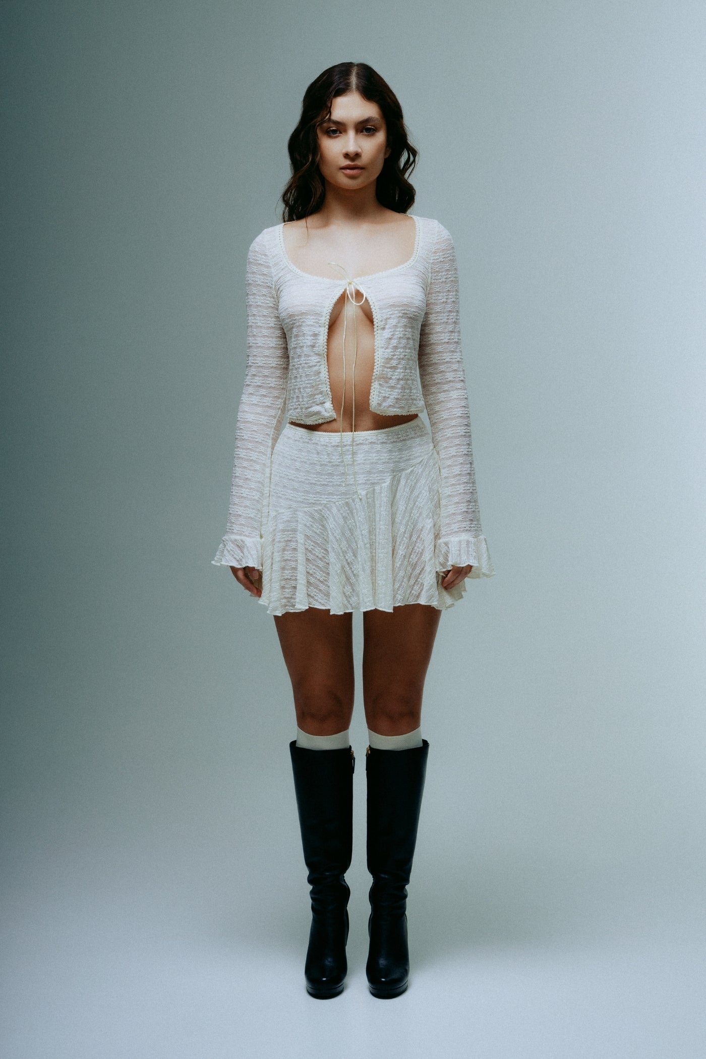 A model wearing the dreamlace top in a white background. 100% deadstock lace material. 