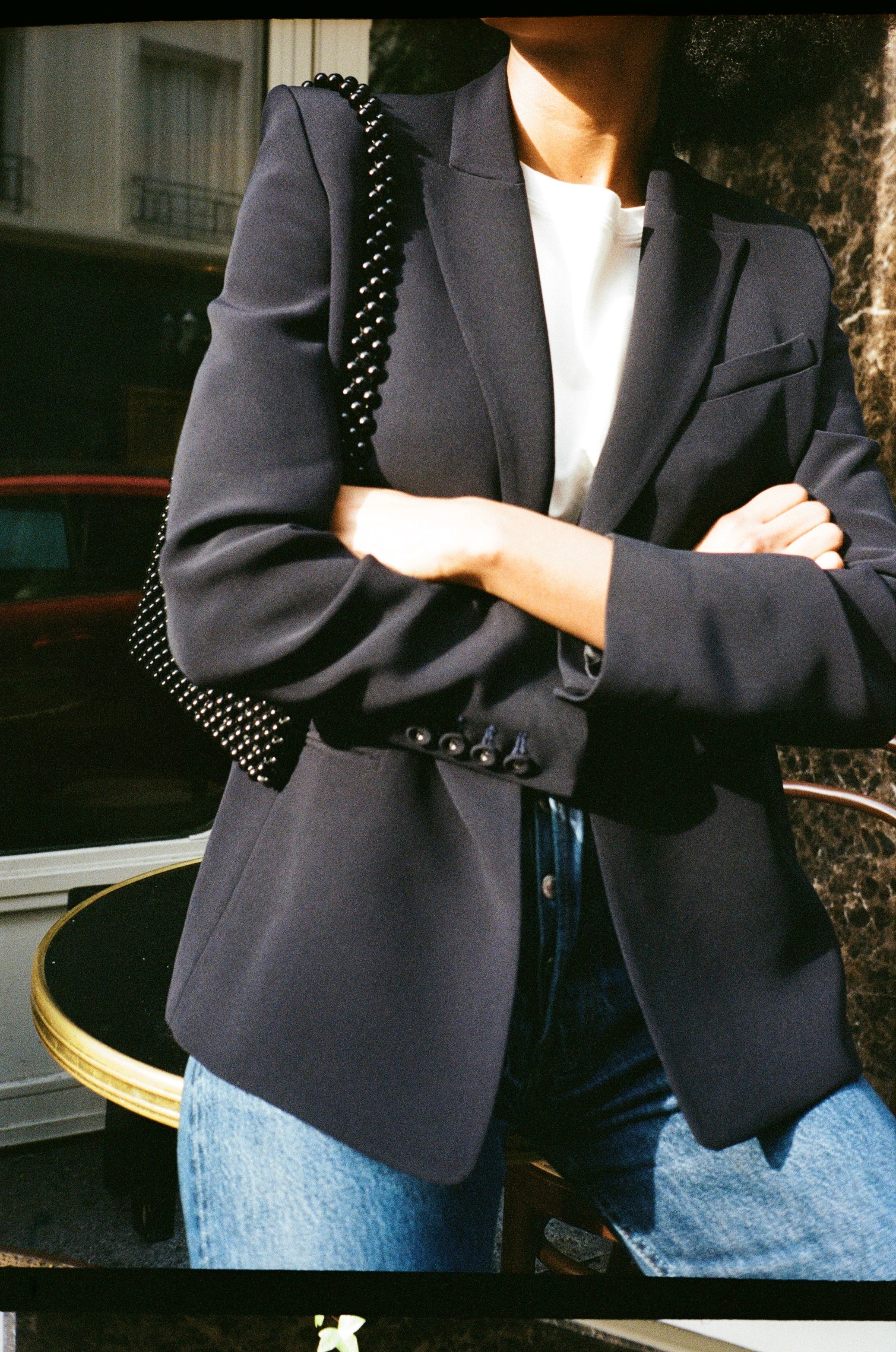 A model wearing the diana midnight blue blazer in an aesthetically outside background. 100% made from sustainable wool. 