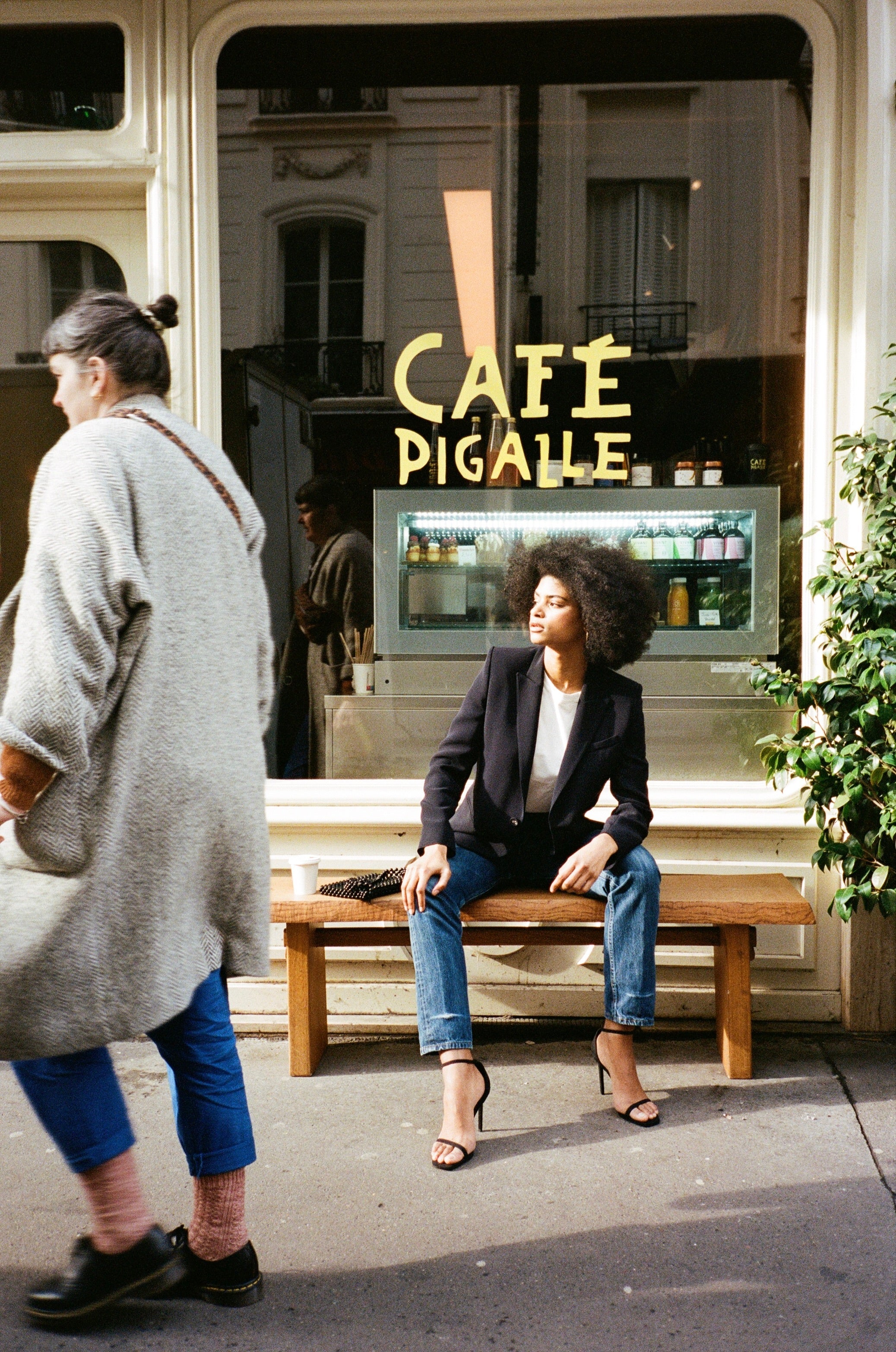 A model wearing the diana midnight blue blazer in an aesthetically outside background. 100% made from sustainable wool. 