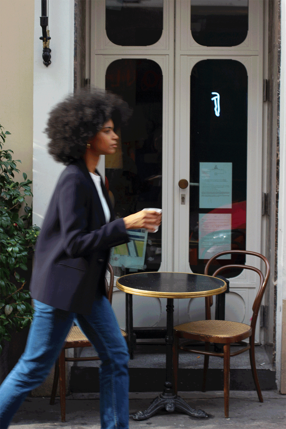 A model wearing the diana midnight blue blazer in an aesthetically outside background. 100% made from sustainable wool. 