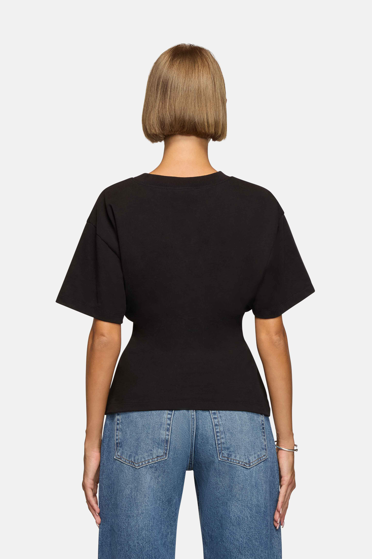 A model wearing the black eero tee in a white background. 100% made from cotton. 