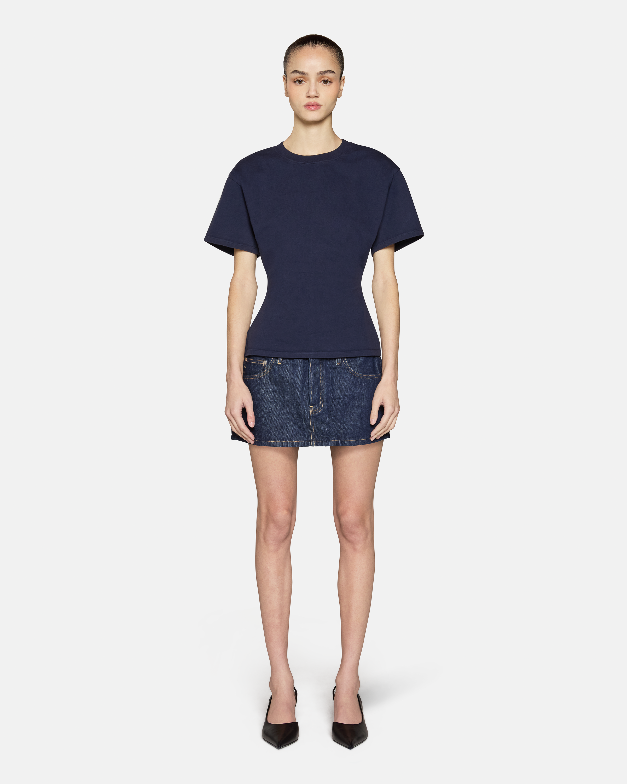 A model wearing the navy eero tee in a white background. 100% made from cotton.
