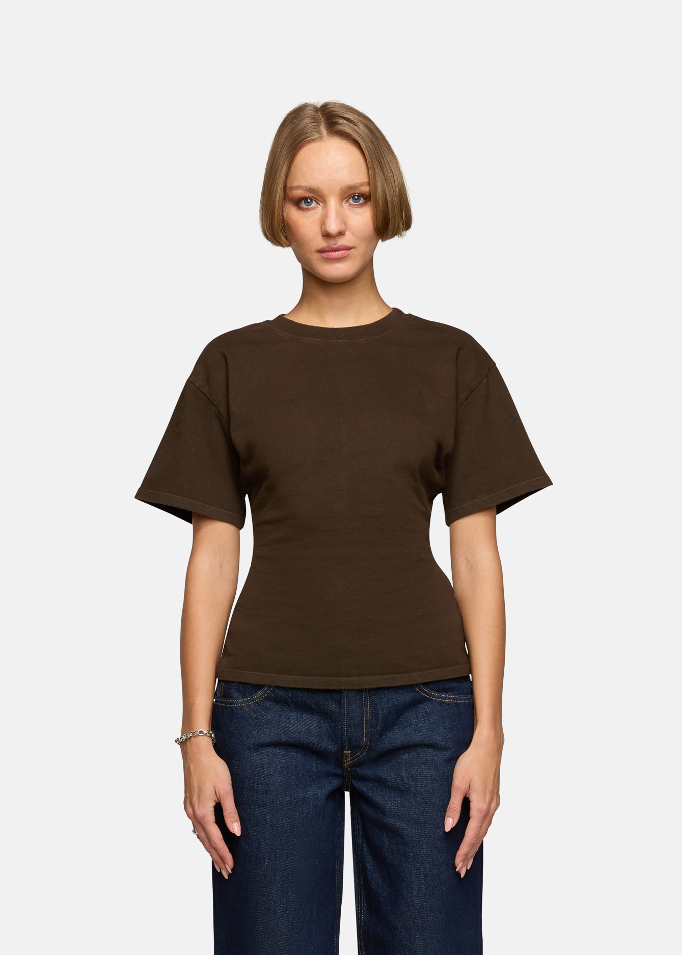 A model wearing the saddle eero tee in a white background. 100% made from cotton.