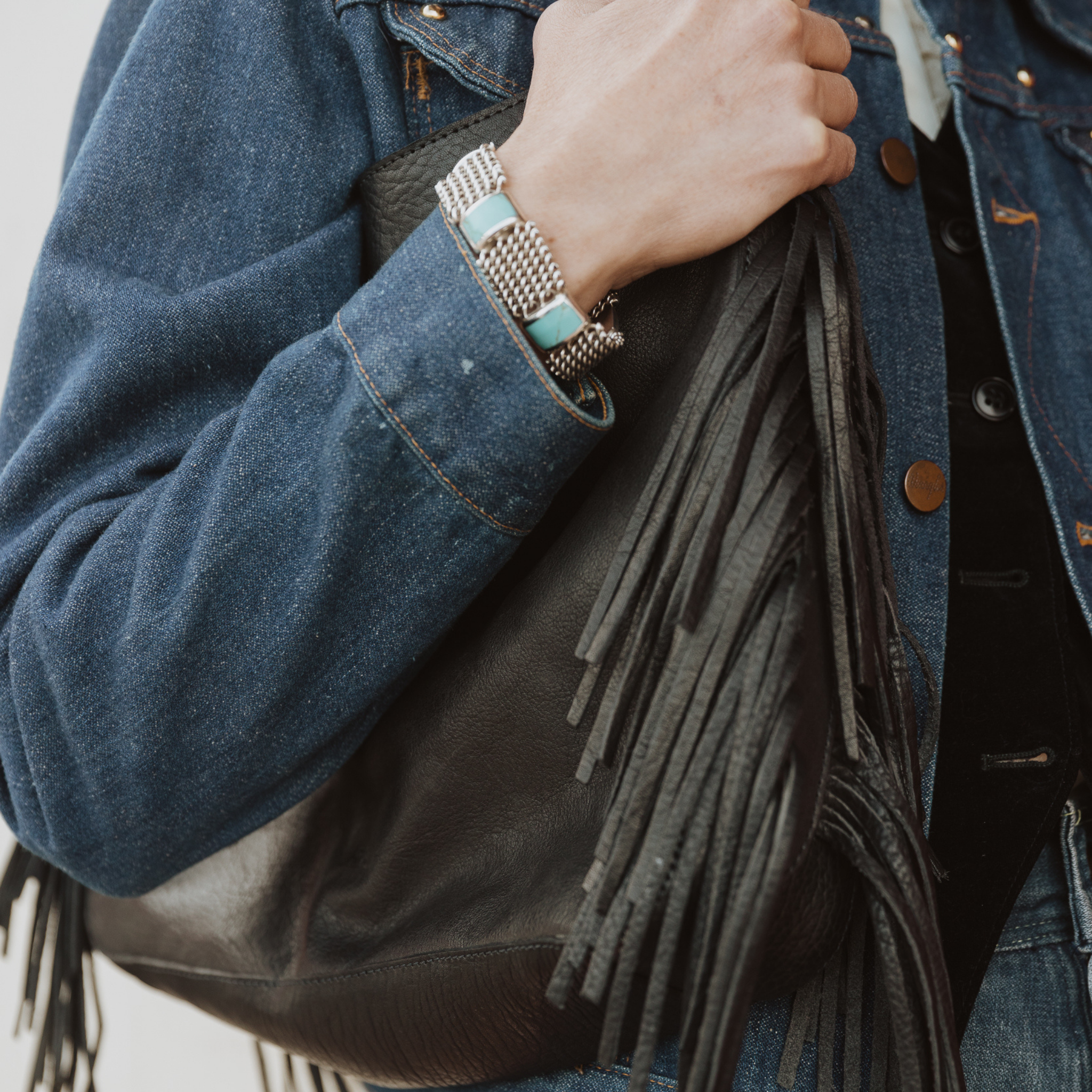 A model wearing the fringe hobo. Leathers are sourced from regenerative ranches. CLOSE UP 
